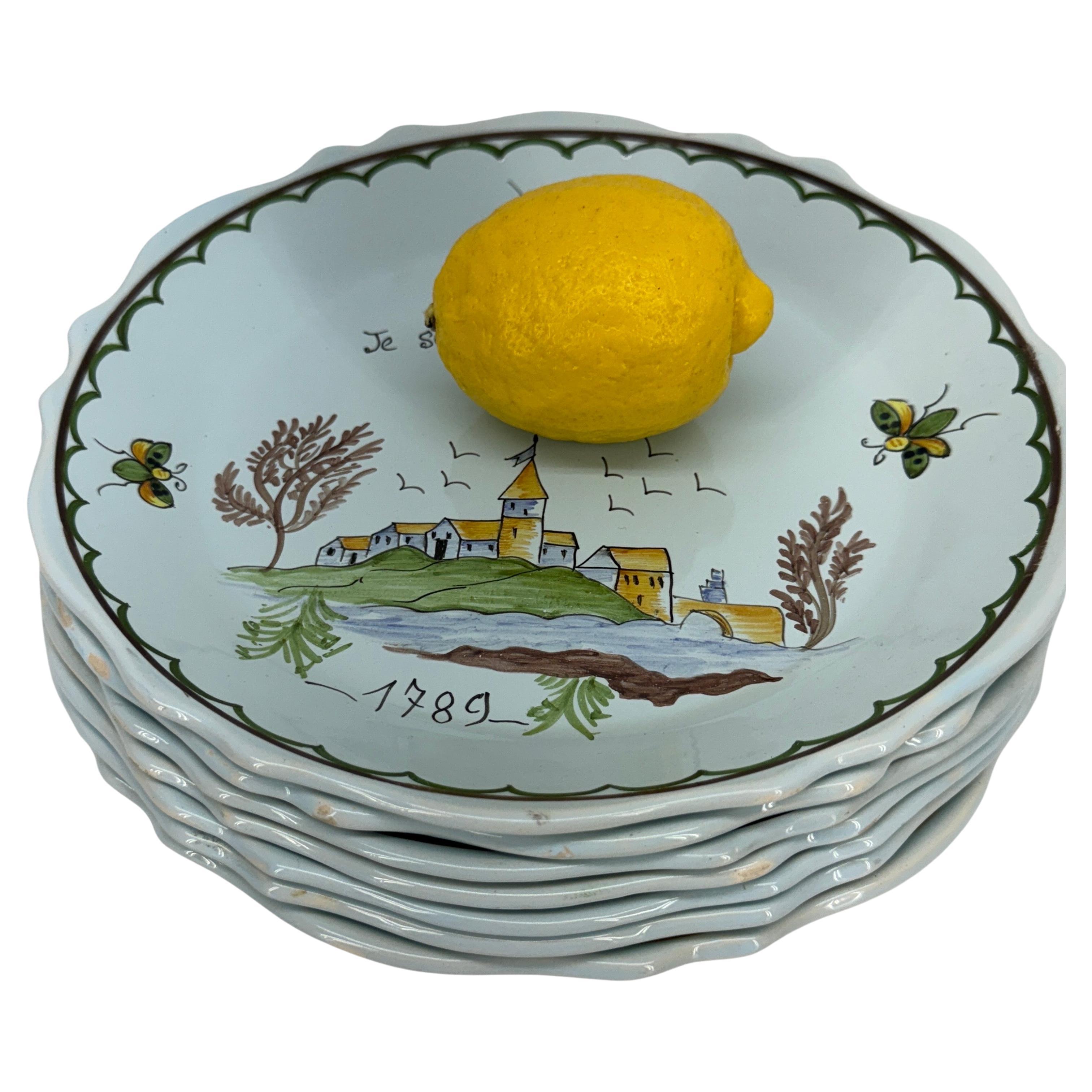 French Liberte 1789 Faience Revolution Plates, France 

This collection of glazed fait main or hand-painted scalloped plates commemorate the bicentennial of the French Revolution. The words on these plates feature Je Suis Liberte and L'immortalite.