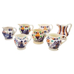 Set of 7 Gaudy Jugs