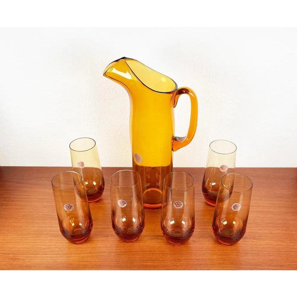 Carafe et verres à boire en verre ambré de la série Jagdhaus de l'Allemagne du milieu du siècle par Wilhelm Braun-Feldweg pour Hirschberg, années 1960, ensemble de 7, en très bon état. Conçu de 1950 à 1959 Cette pièce porte une marque