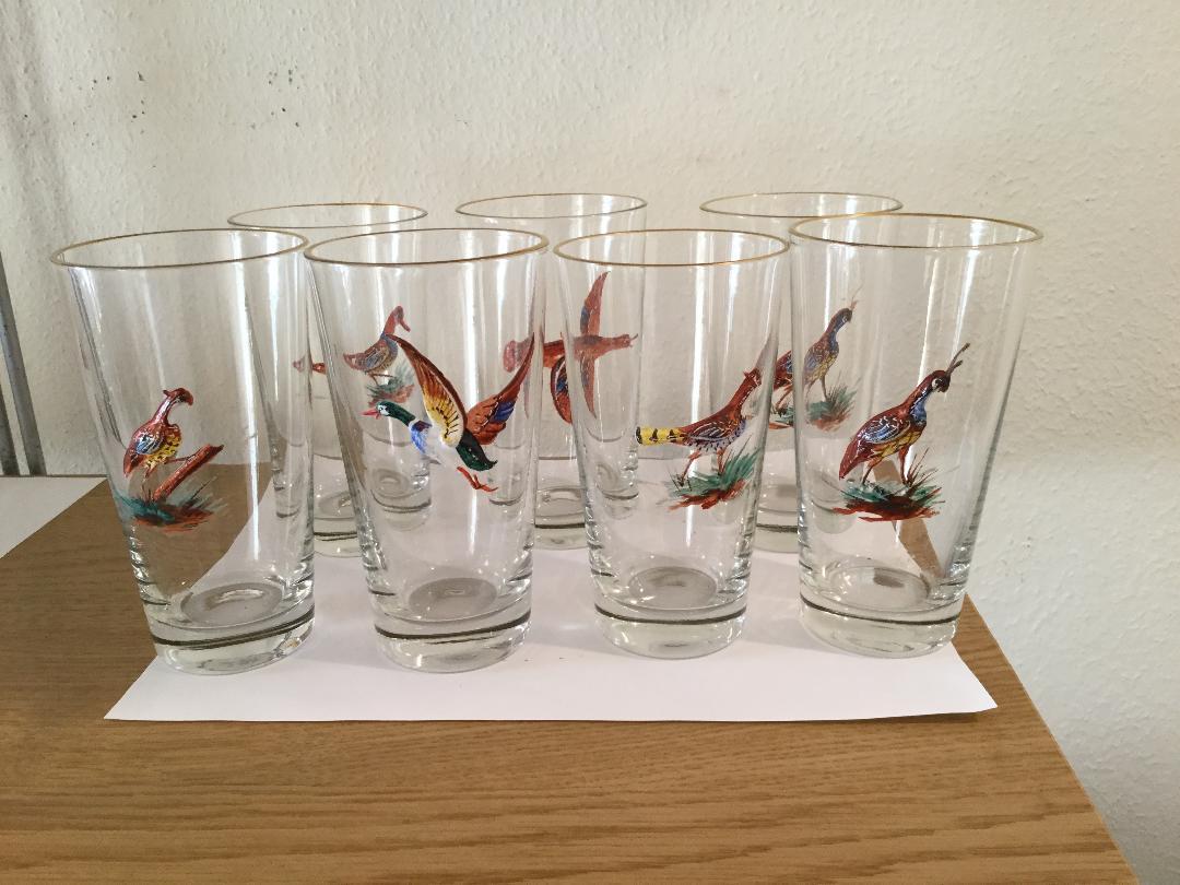 A scarce set of 7 highball bar glasses with hand painted enameled birds and with a 3 dimensional look. These birds are actually built up on the glass to give this effect which can be seen in the photographs. There are several different types of game