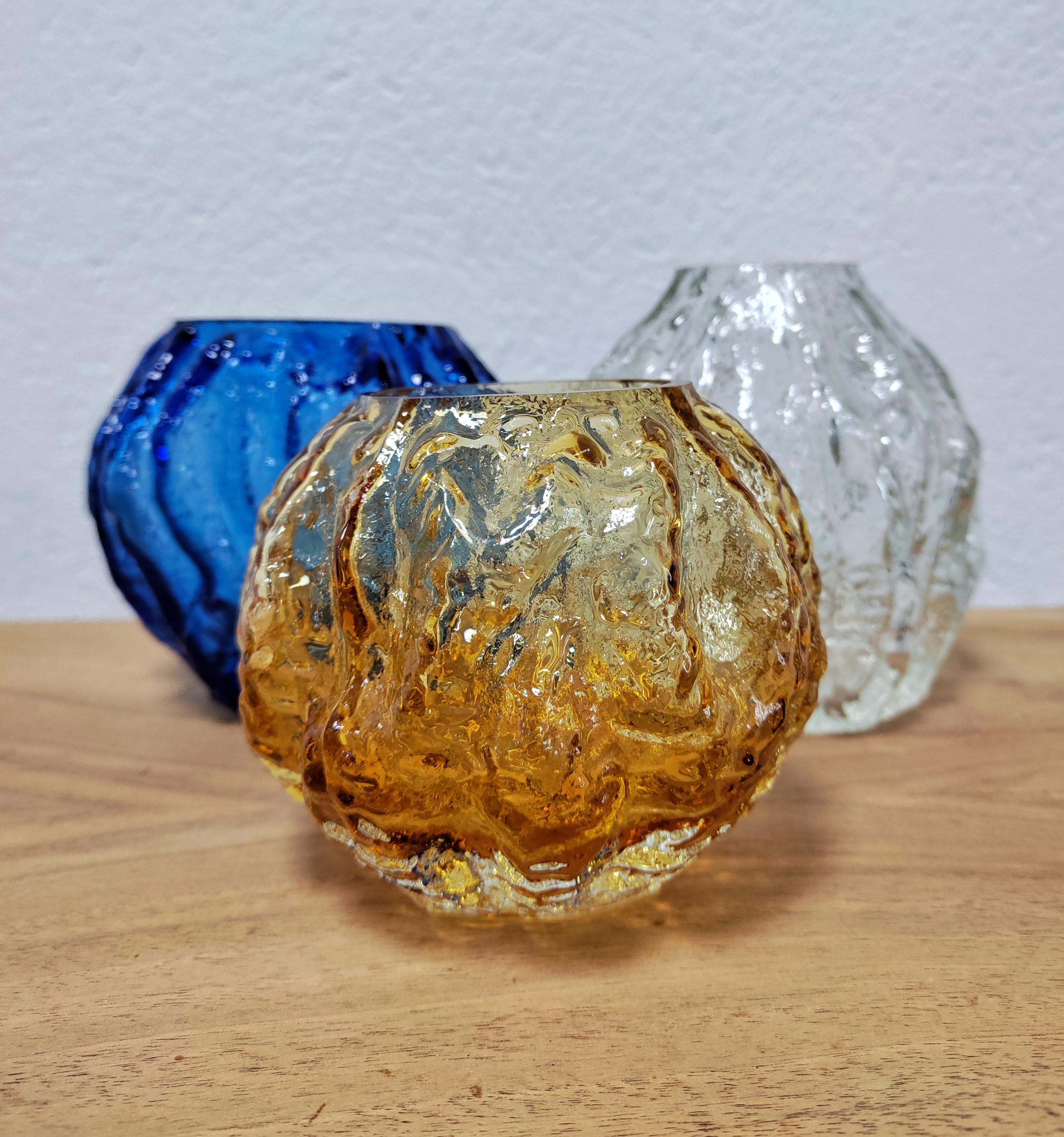 In this listing you may find a collection of 6 Mid-Century Modern glass vases in various sizes, shapes and colours. They were manufactured by Ingrid Glass, a renowned West German glass manufacturer. Each vase features tree bark texture and is made