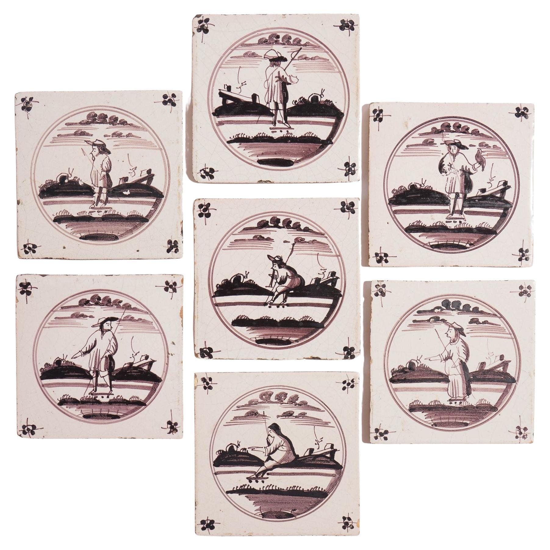 Set of 7 mulberry decorated figural Delft faience tiles, c. 1680-1700 For Sale