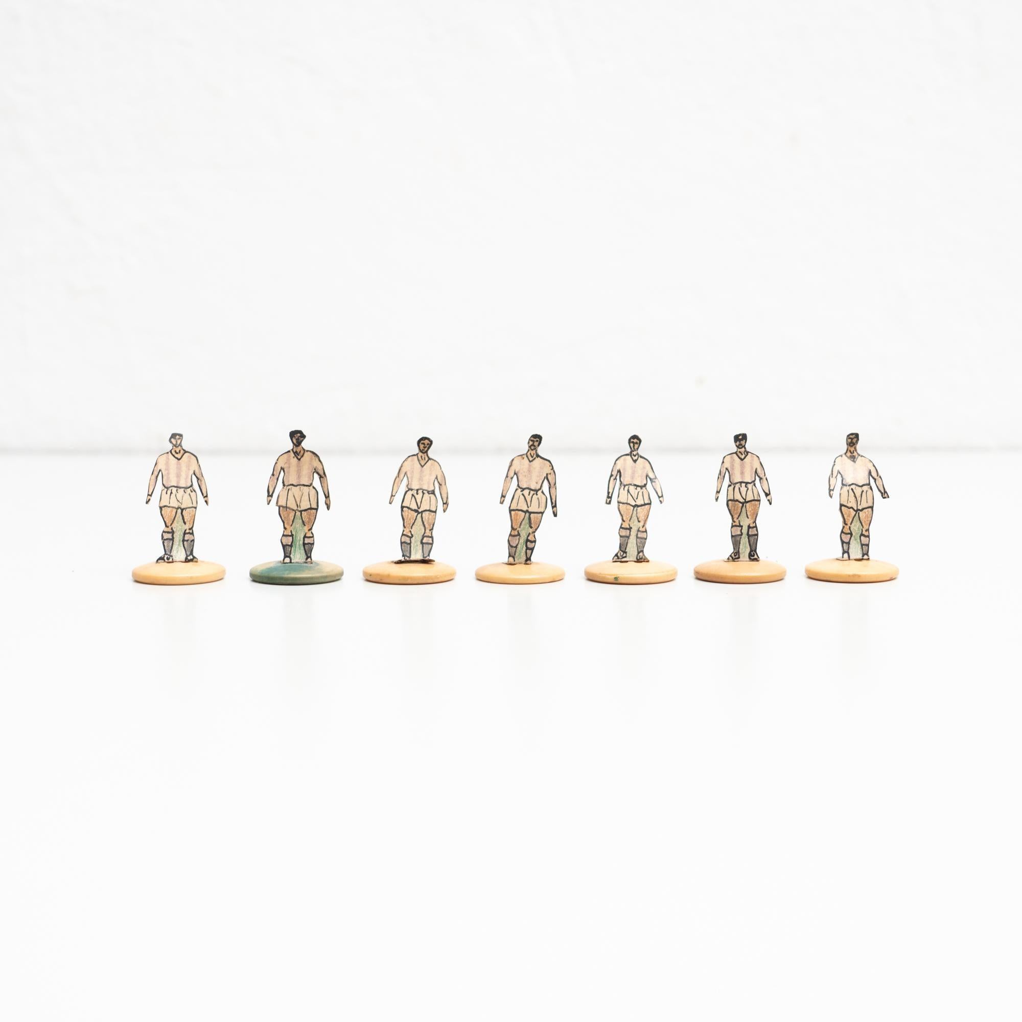 Set of seven table button soccer game players. Traditional figures used to play this classic button Spanish game.     The players are build buy attaching a printed photography or drawing of an actual football soccer player to a clothing button.    