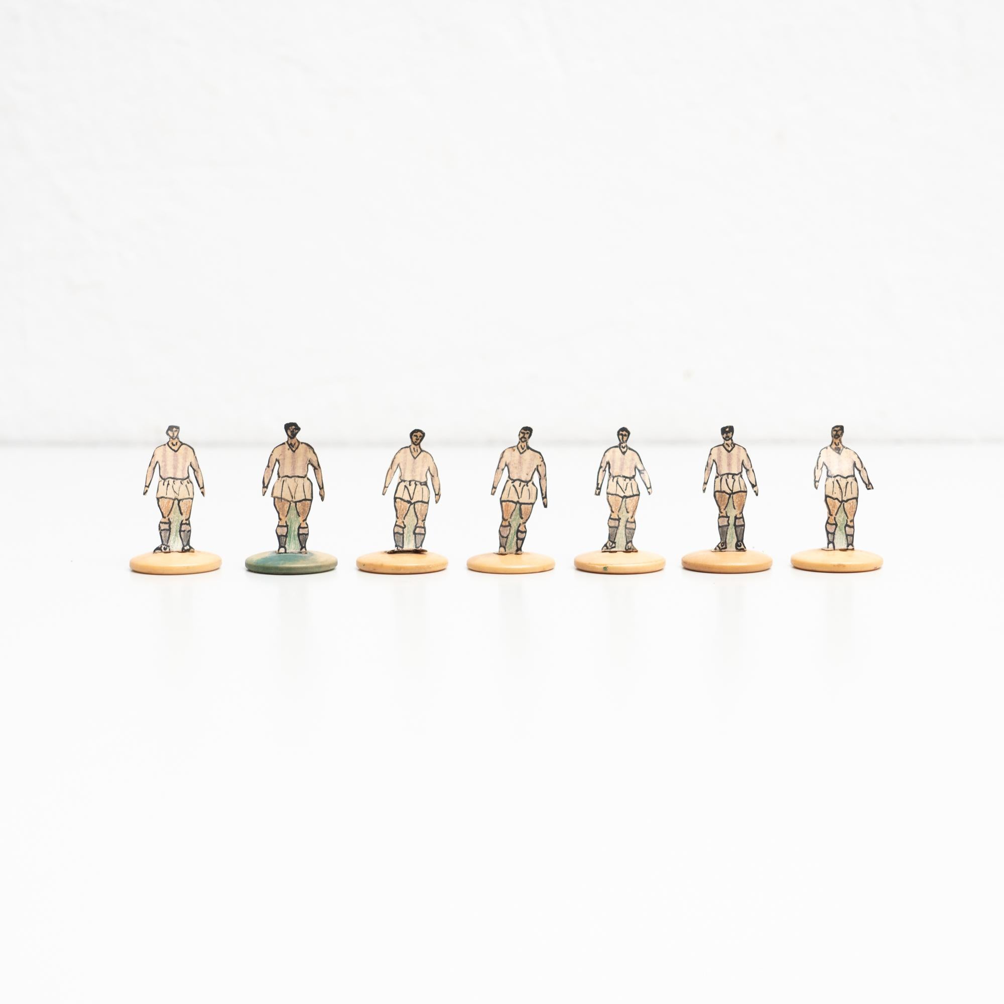 Set of seven table button soccer game players. Traditional figures used to play this classic button Spanish game. 

The players are build buy attaching a printed photography or drawing of an actual football soccer player to a clothing button.