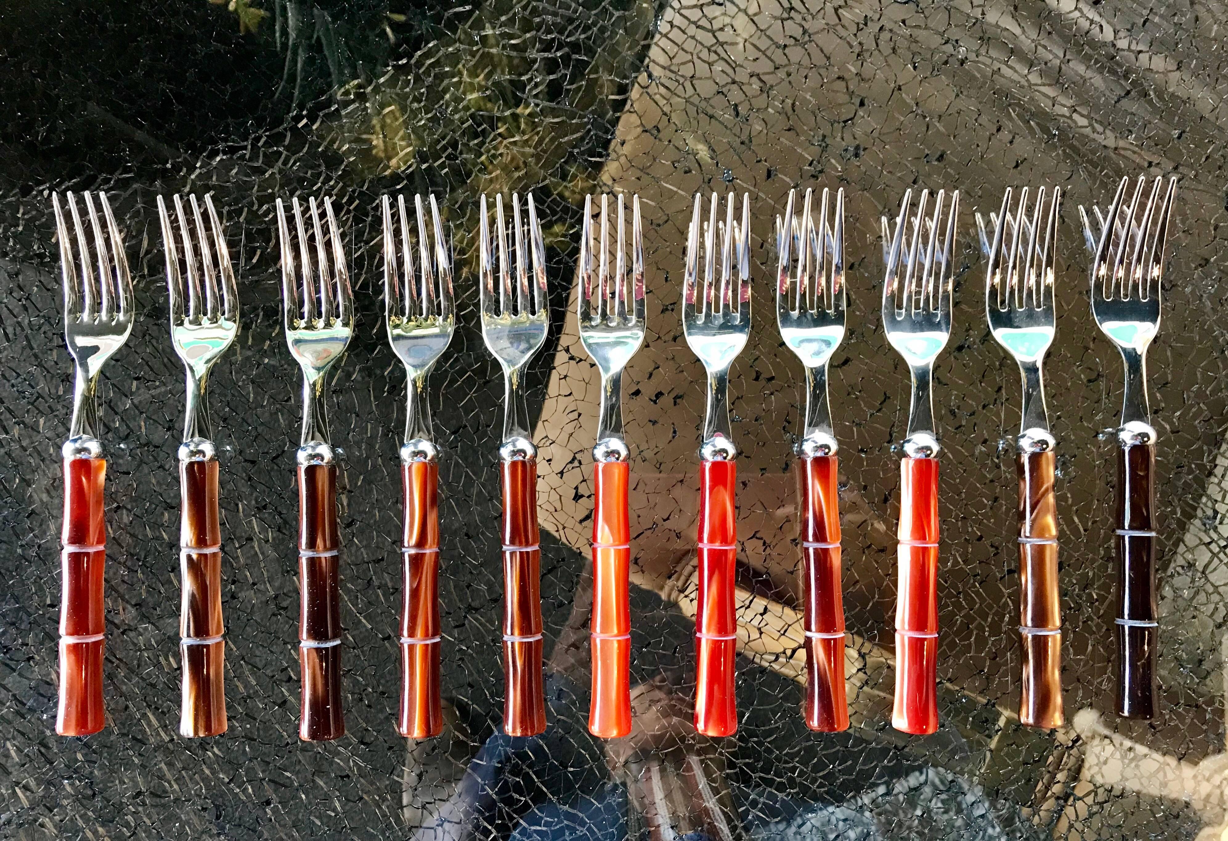 A gorgeous set of flatware made in Italy of 18/10 stainless. The acrylic (Lucite) handels are done in bamboo style in an amazing mother-of-pearl look in colors or browns and russet. No 2 pieces are exactly alike. Purchased for a very upscale