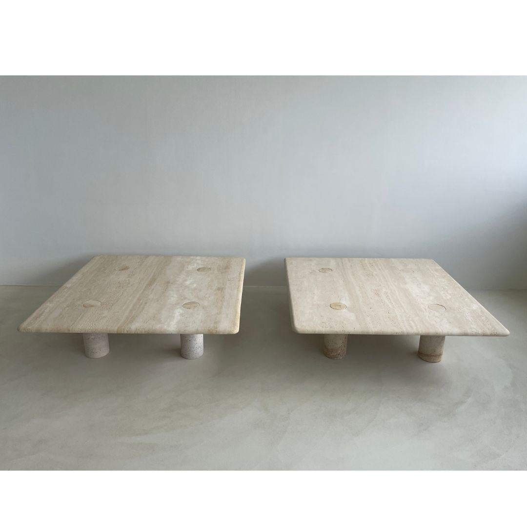 These large square travertine coffee tables were designed by legendary architect and industrial designer Angelo Mangiarotti and manufactured by Up&Up Italy in the 1970s. 
The honed travertine top is crafted from one piece of stone and features