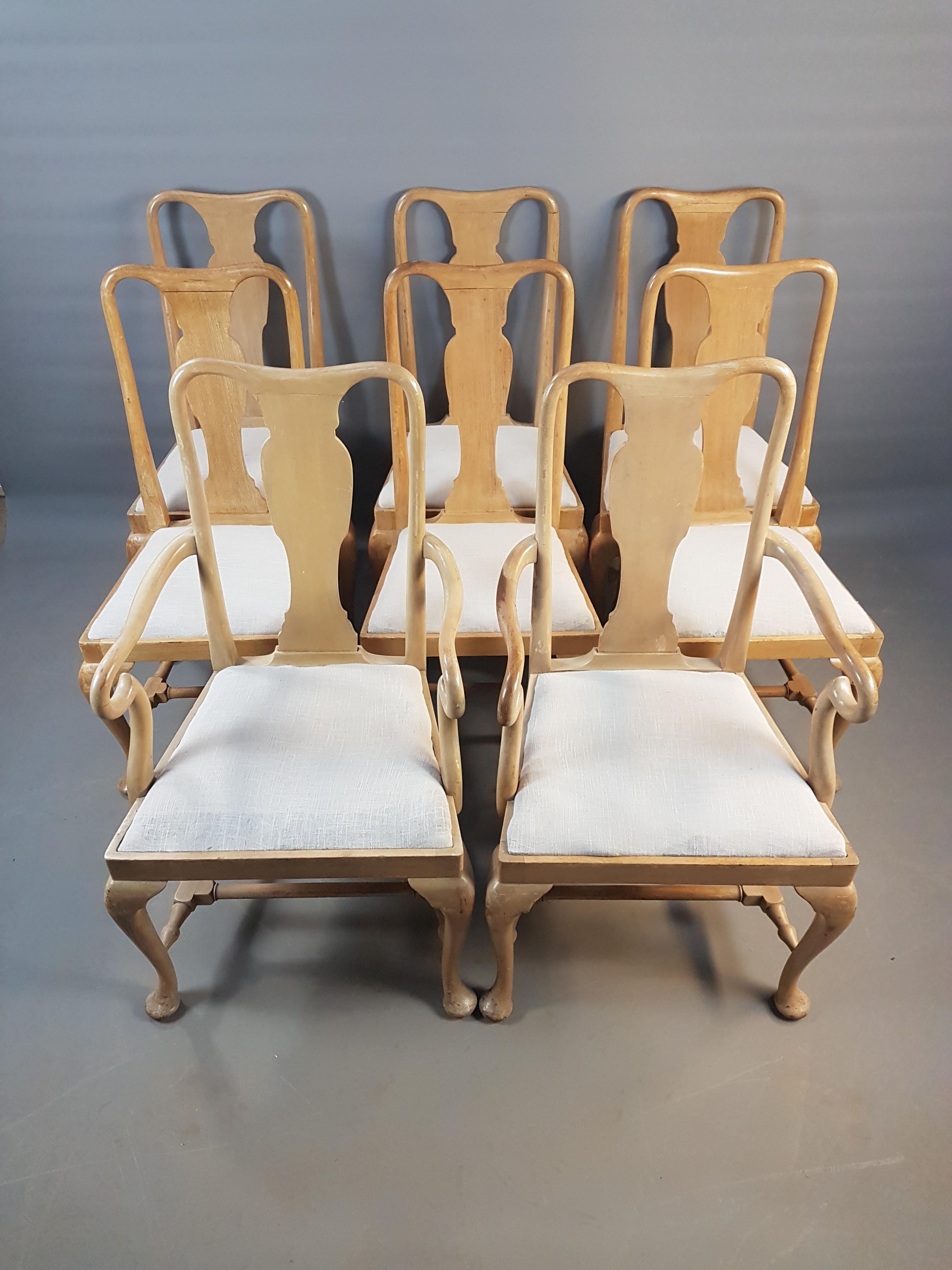 A charming set of eight 1920s pale mahogany dining chairs in good structural condition. The finish does have wear and tear, knocks and old repairs. The seat pads have a grey Stoney linen liner ready for reupholstering in chosen fabric. The carver