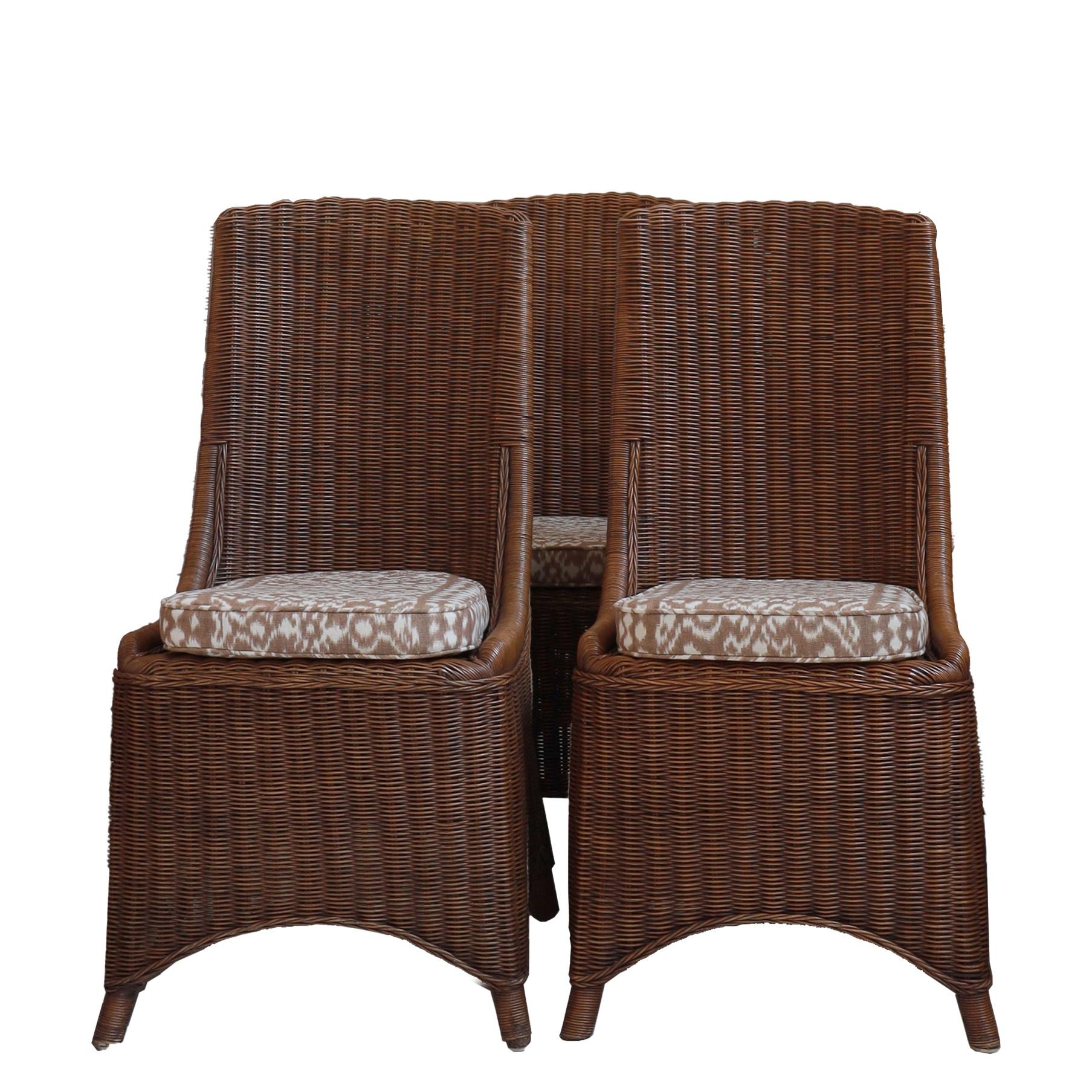 A set of eight mid-20th-century rattan chairs with gently flared high backs and subtly curved bases typical of a design rooted in the 1950s–60s, when organic materials and artisanal craftsmanship were increasingly embraced in European
