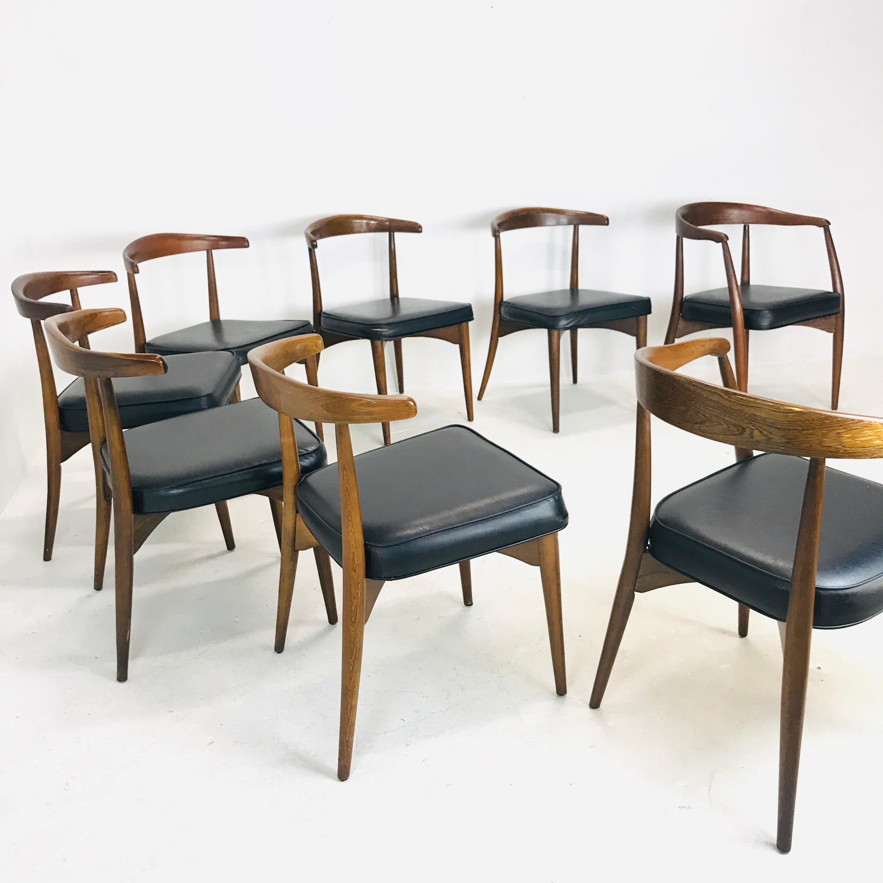 2 armchairs and 6 side chairs by Lawrence Peabody in oak, walnut and black vinyl, circa early 1960s. Armchairs measure: 30.25