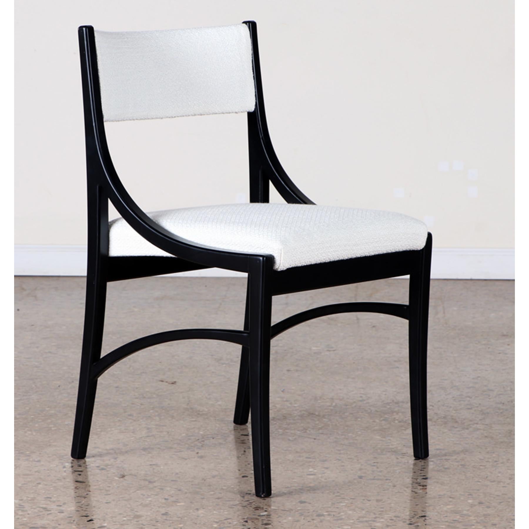 A set of 8 vintage dining chairs ebonized wood, off- white bouclee upholstery, and down swept arms, circa 1970s