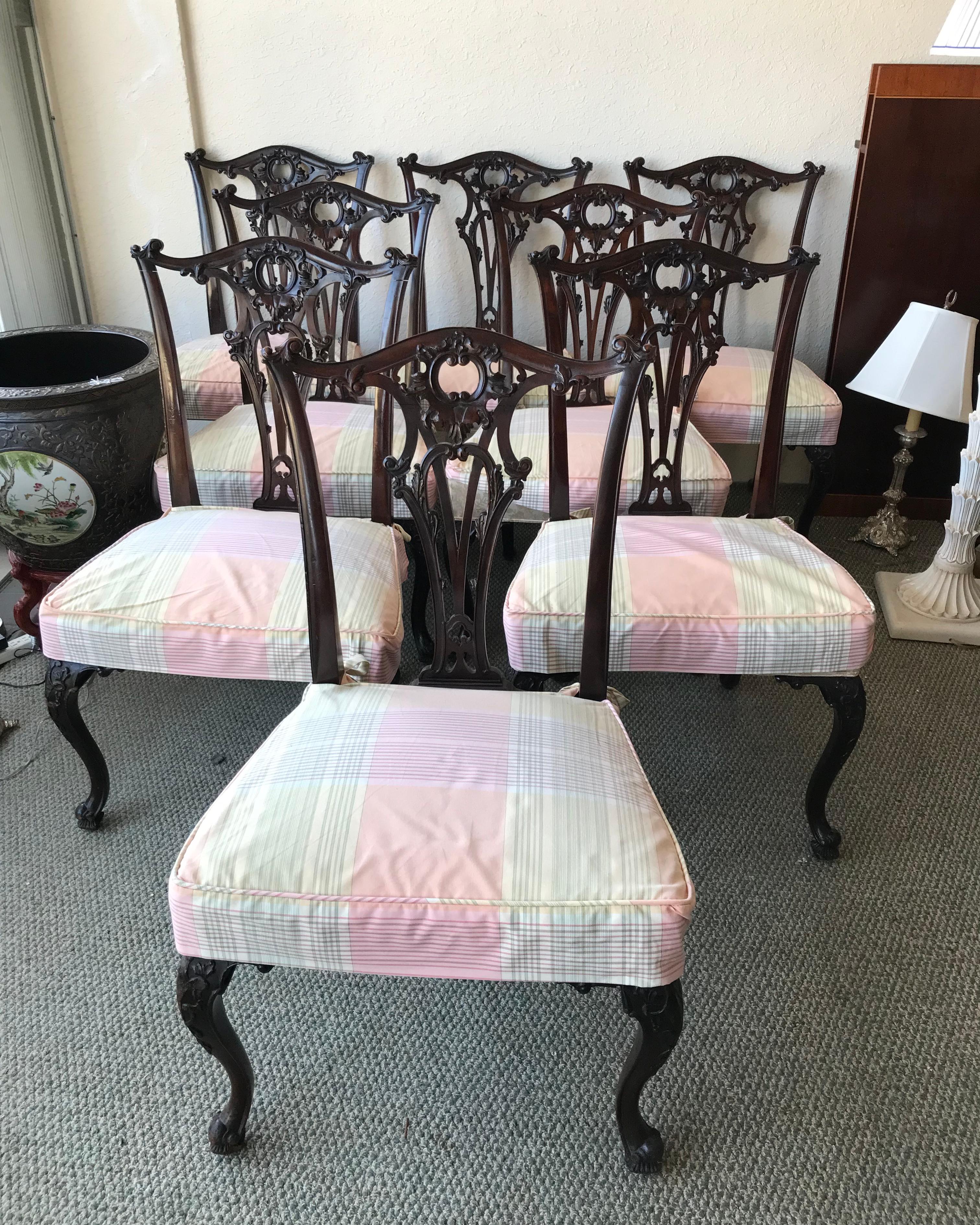 Exquisite and detailed carving. In the Chippendale style.
Rich, deep mahogany. The seats are nice and wide for comfortable
seating and are beautifully upholstered. The chairs terminate in
