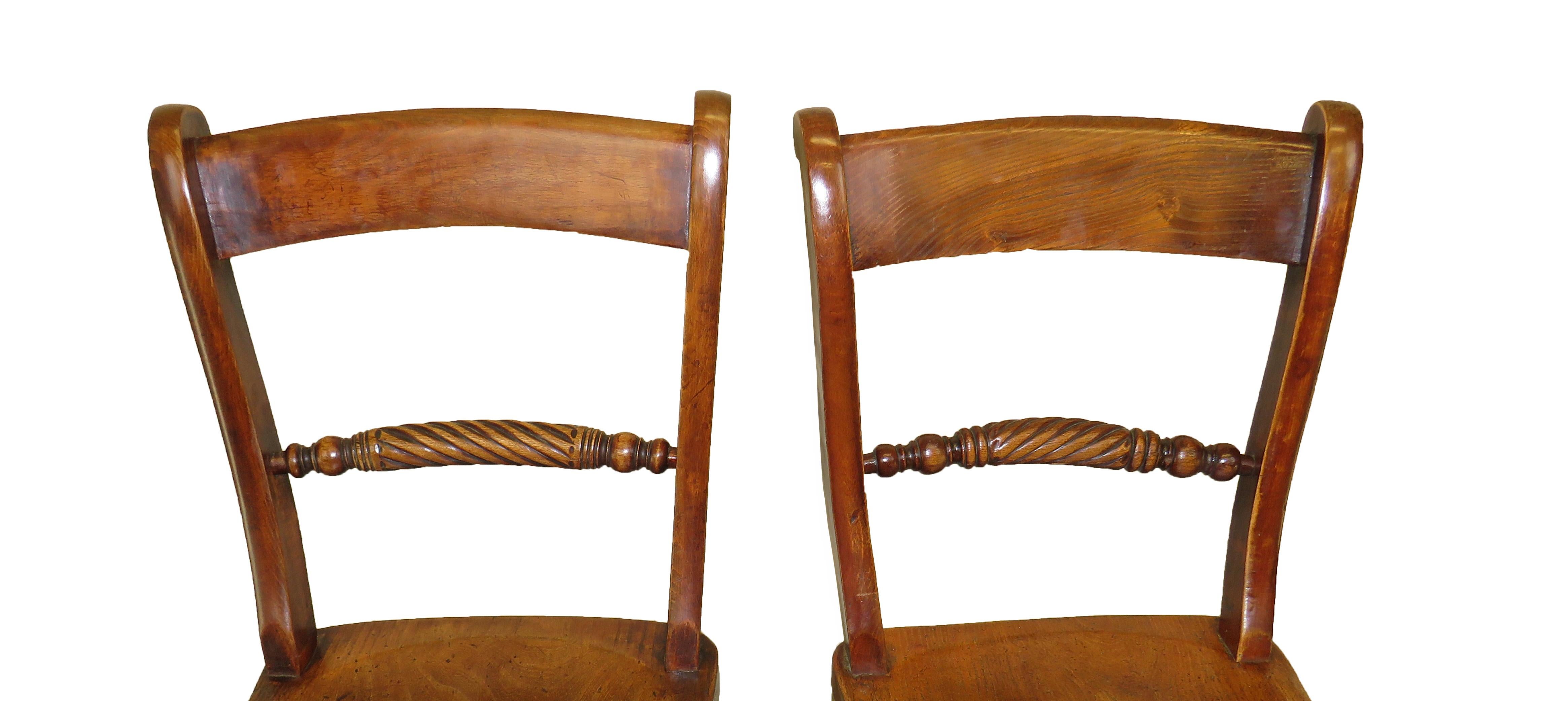 A charming set of eight mid 19th century beech and elm kitchen Windsor chairs, having elegant rope twist turned backs raised on turned legs and stretchers.

These charming chairs are a 