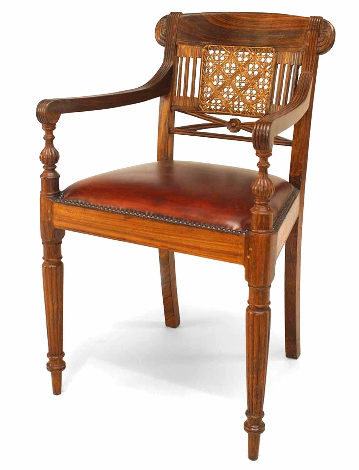 Set of 8 English Anglo Indian hardwood arm chairs with caned splat above a leather upholstered seat & turned reeded legs (19th Century). 
  