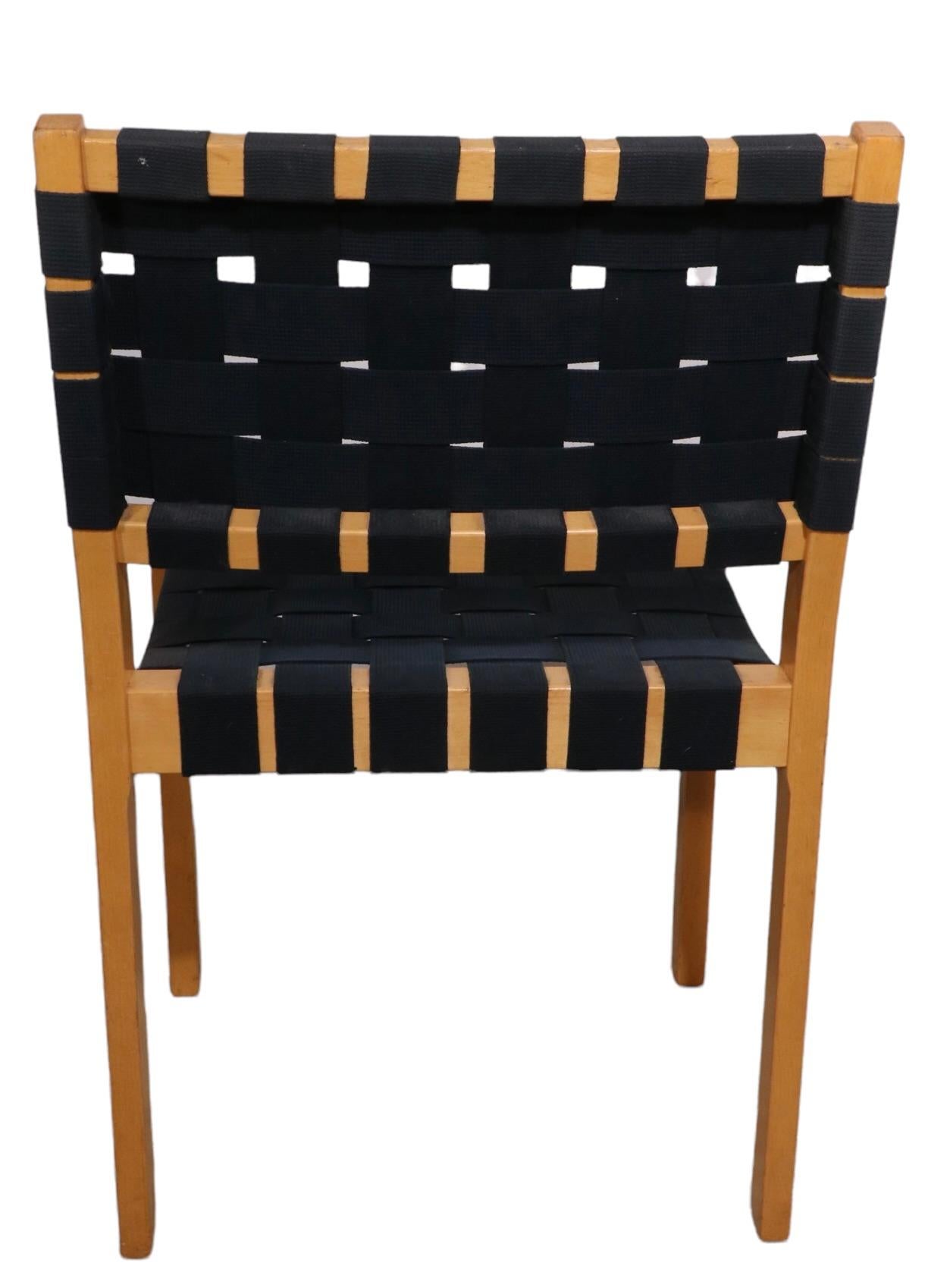 Exceptional set of eight dining chairs designed by Alvar Aalto, made by Artek, distributed by ICF NY. The chairs are all structurally sound and sturdy, the webbing shows some cosmetic wear, fading, etc, but is all strong and ready to use - we