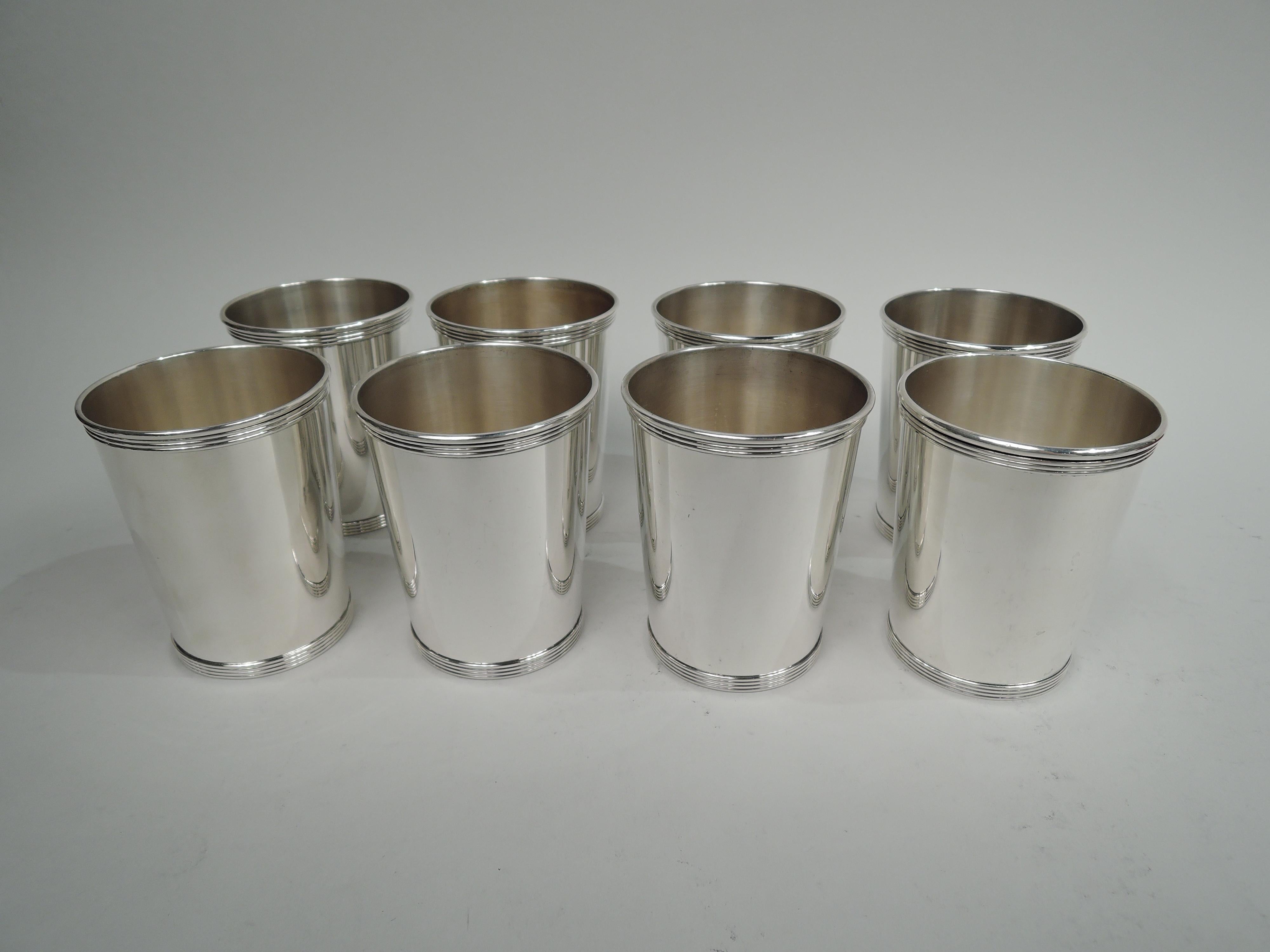 Set of 8 traditional sterling silver mint juleps. Made by Alvin in Providence. Each: Straight and tapering sides and reeded rim and foot. Fully marked including maker’s stamp and no. S251. Total weight: 29.8 troy ounces.