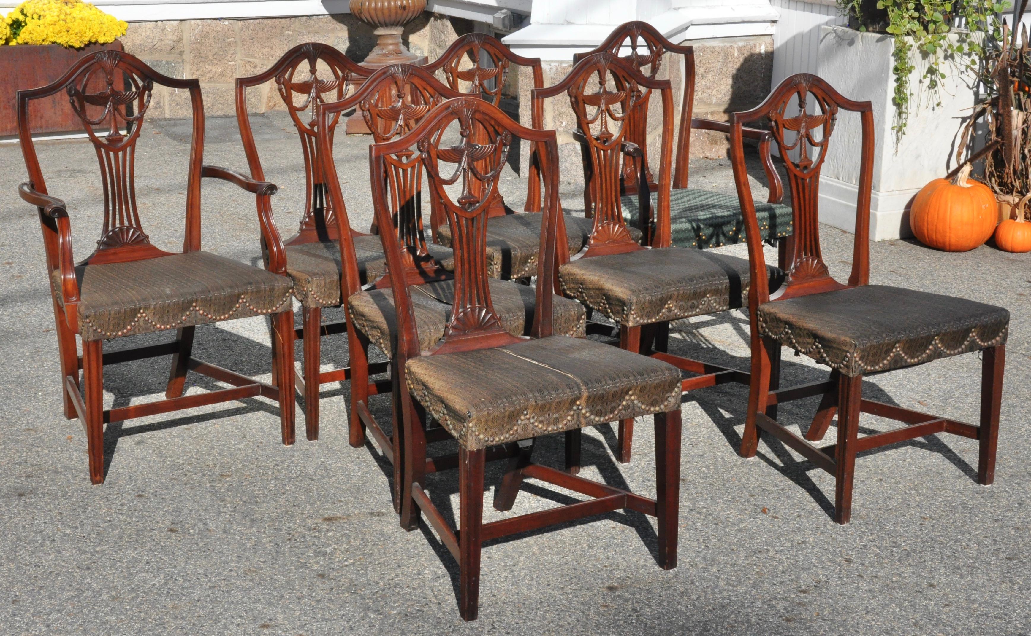 Set of Eight American Federal Dining Chairs, two arms and six sides. Open shield back Hepplewhite design with urn and swags and 