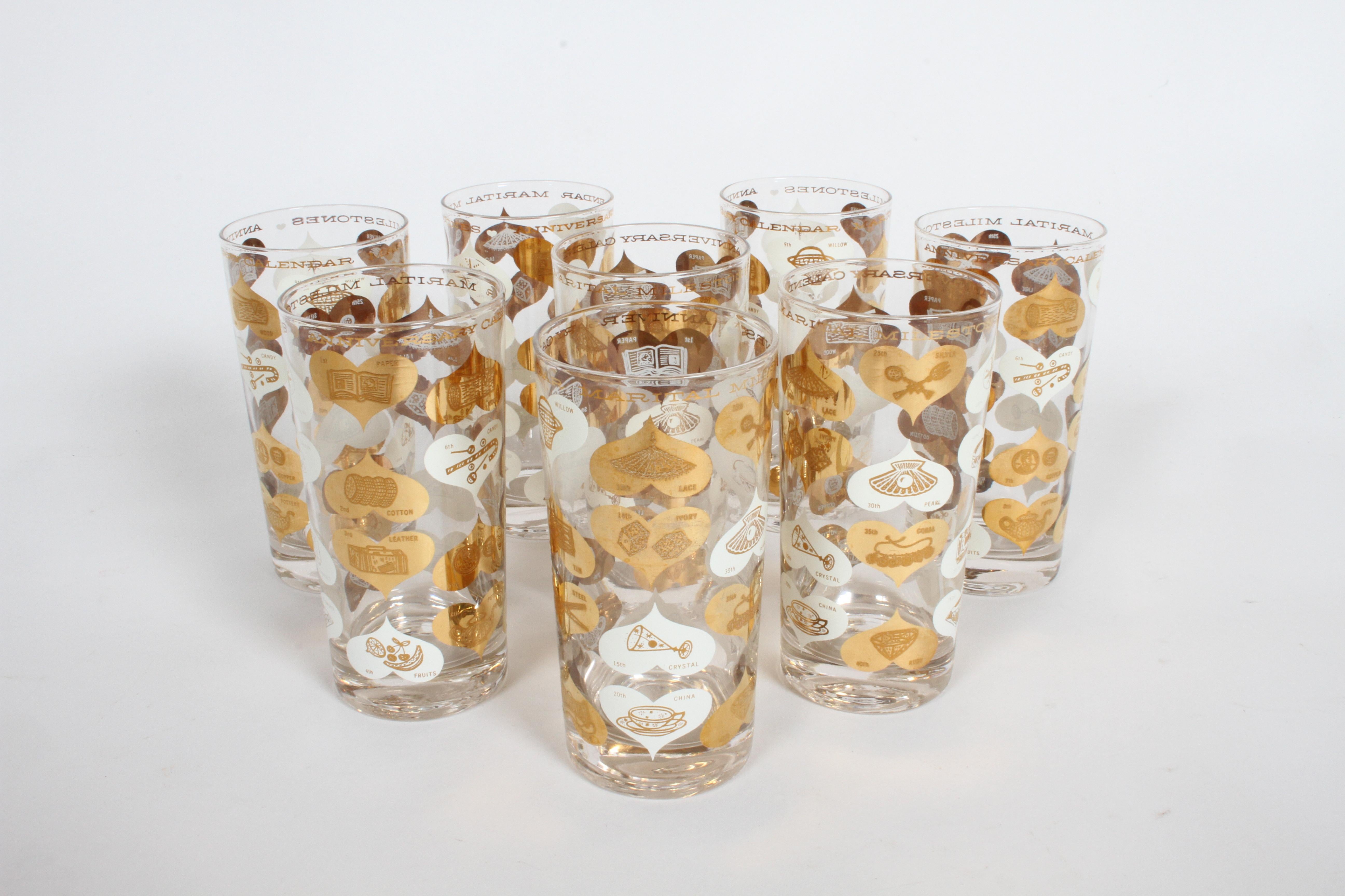 Set of 8 Mid-Century Modern highball barware glasses, titled Anniversary Calendar of Marital Milestones, plated with 22-karat gold. Goes from 1st anniversary of paper to 75th-Diamond. One glass, has small chip to inside rim, going to try to get it