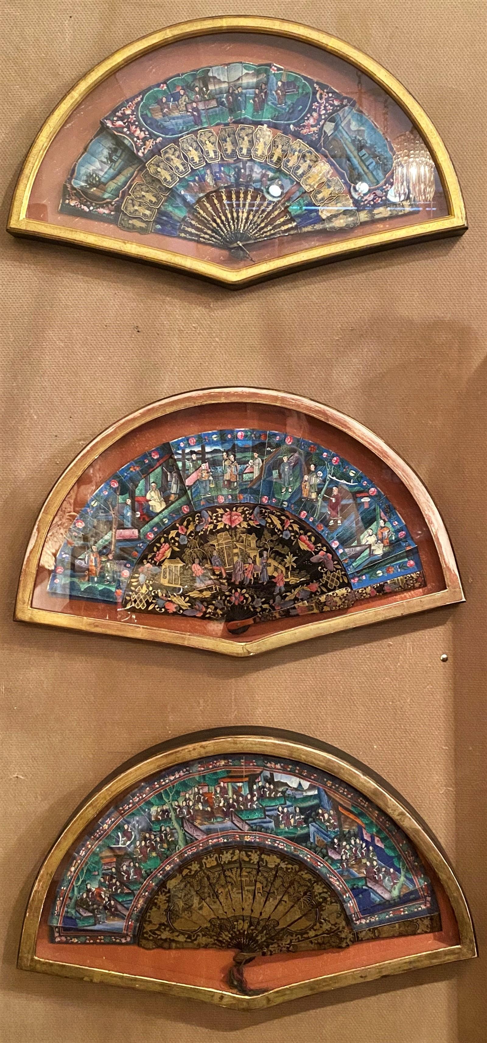 This is a beautiful collection of antique fans mounted in fan-shaped frames. Each fan is lovely in its own right. The colors and images on the fans are bright and clear.
 