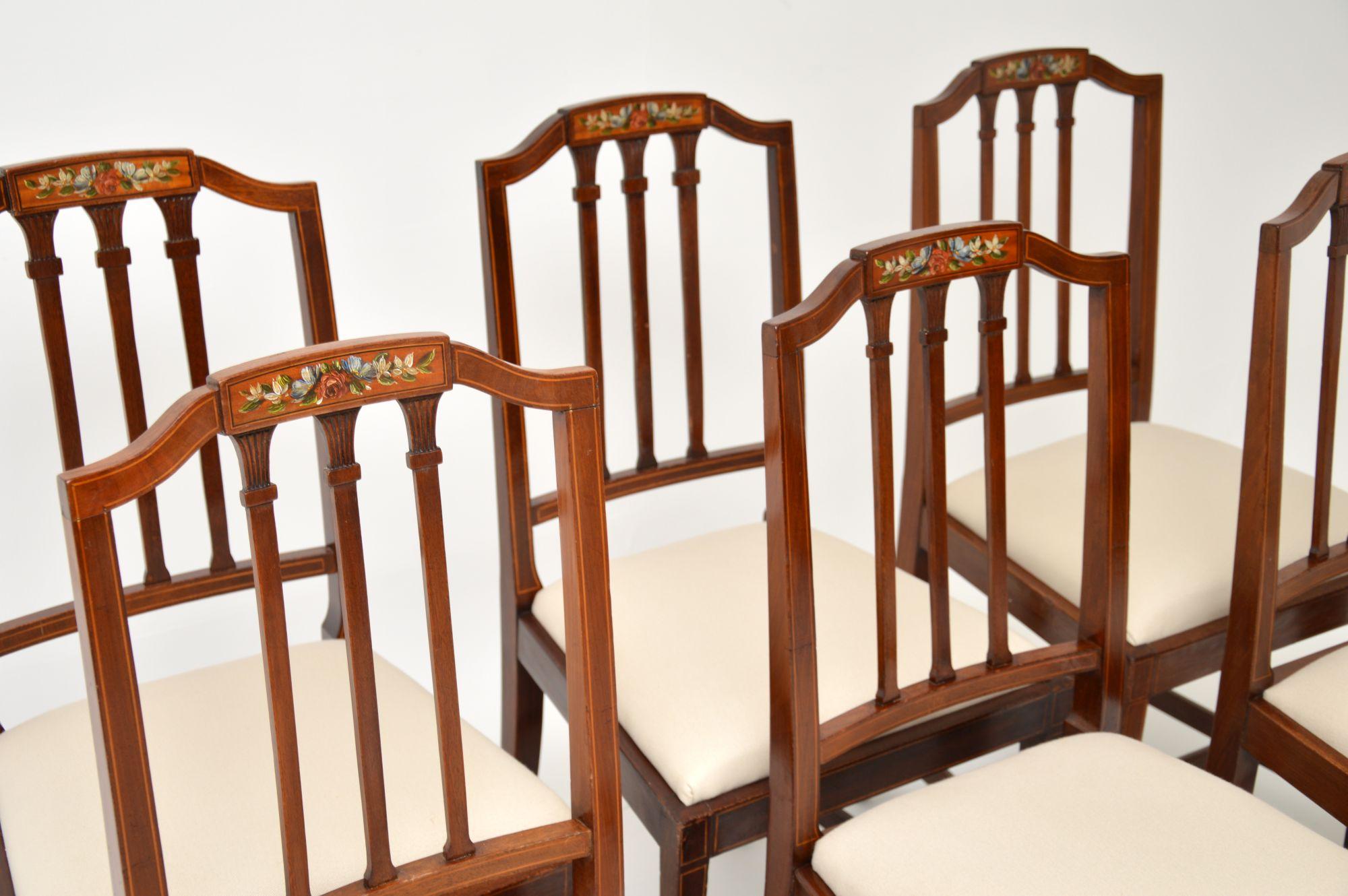 A stunning set of antique Edwardian dining chairs in wood. These were made in England, they date from around the 1900-1910 period.
The quality is superb, they are solid wood with satin wood inlay and beautifully hand painted floral motifs on the