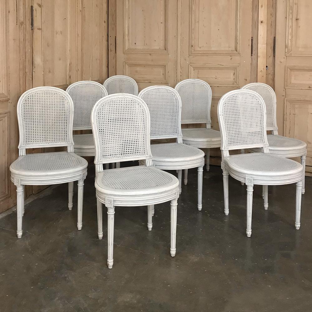 Set of 8 antique French Louis XVI painted dining chairs feature a patinated white painted finish and caned back and seats for lightweight, cool comfort in style,

circa early 1900s

Each measures: 36 H x 19 W x 18 D, seat 17 H.