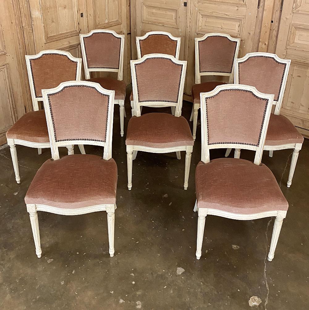 Set of 8 antique French Louis XVI painted dining chairs feature timeless classical design combined with a charming crackle painted finish and luxurious taupe mohair upholstery! The frames are embellished with tapered and fluted legs on the fronts