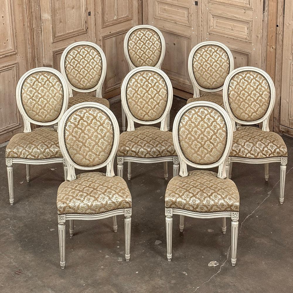 Set of 8 Antique French Louis XVI Painted Dining Chairs with Damascene Upholstery will add a certain sophisticated grace and elegance to your dining experience.  Hand-crafted from select hardwoods, then carefully sculpted in the neoclassical style
