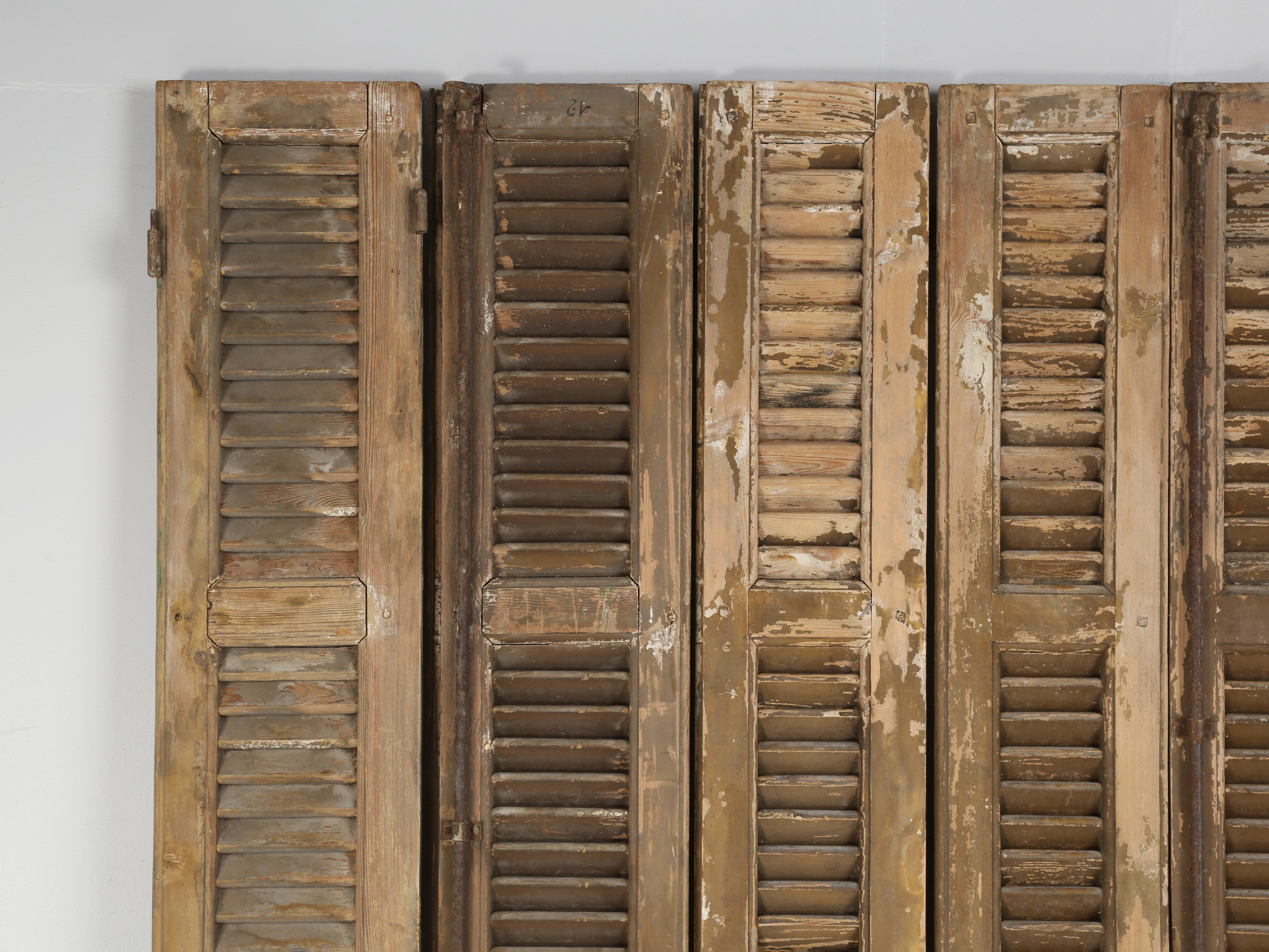 Set of (8) antique shutters removed from a French chateau located in the Brittany region of France. The shutters remain in as found condition and could be used to make a headboard or room divider. They have been in a dry heated warehouse for the