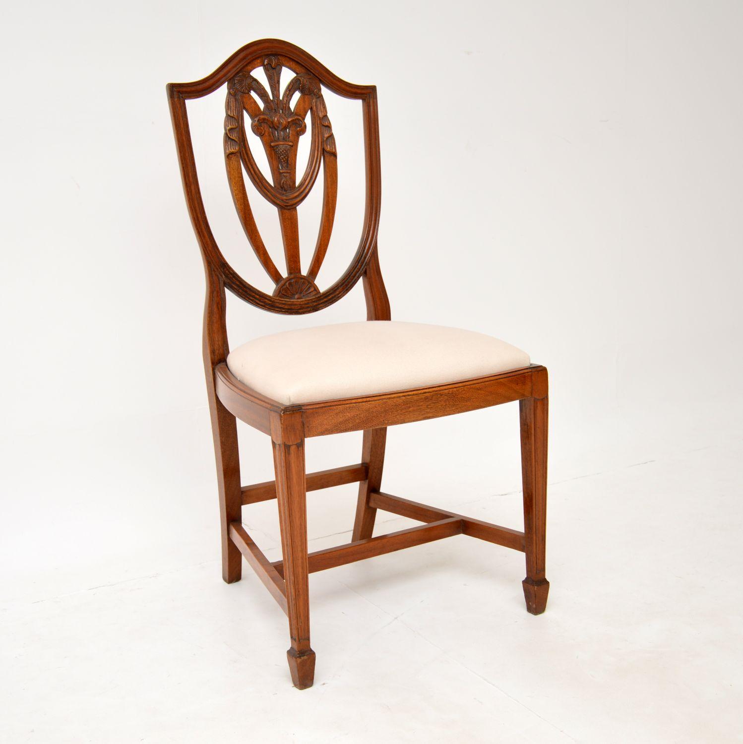 A fantastic set of eight solid wood shield back dining chairs in the antique Georgian style. These were made in England, they date from around the 1930’s.

They are of superb quality, with fabulous carving depicting Prince of Wales feathers. They