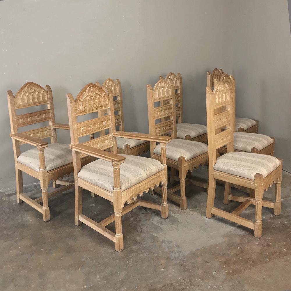 Set of 8 antique Gothic dining chairs includes 2 armchairs was fashioned from solid oak to last for decade after decade! Subtle Gothic influence in the carvings of the seatback and legs provides just the right Old World masculine touch, with