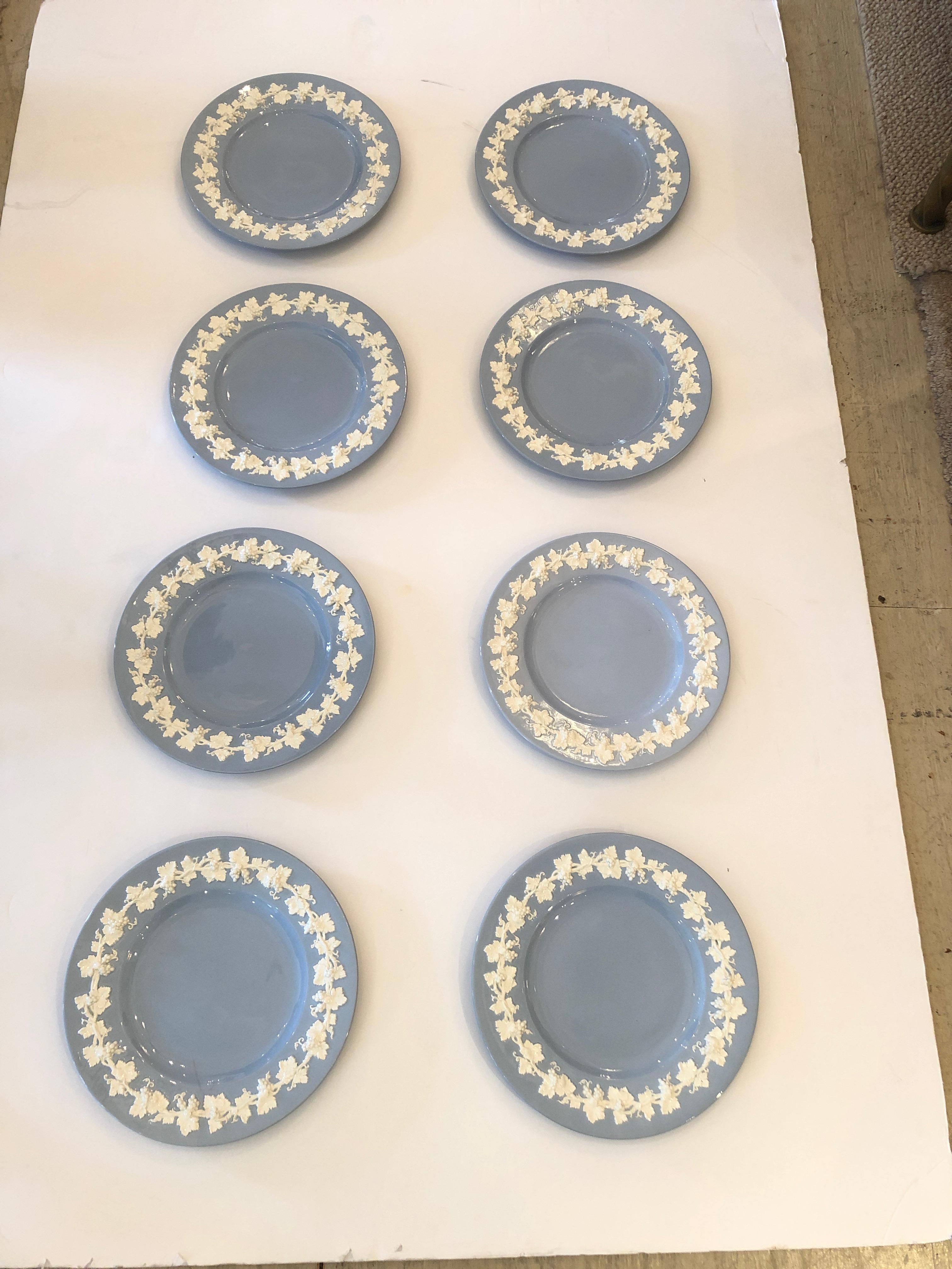 A pretty set of 8 Wedgewood dinner plates in a gorgeous shade of lavender blue having raised cream floral decoration around the periphery. Stamped on back with Queen Ware pattern 2788 Wedgewood England.