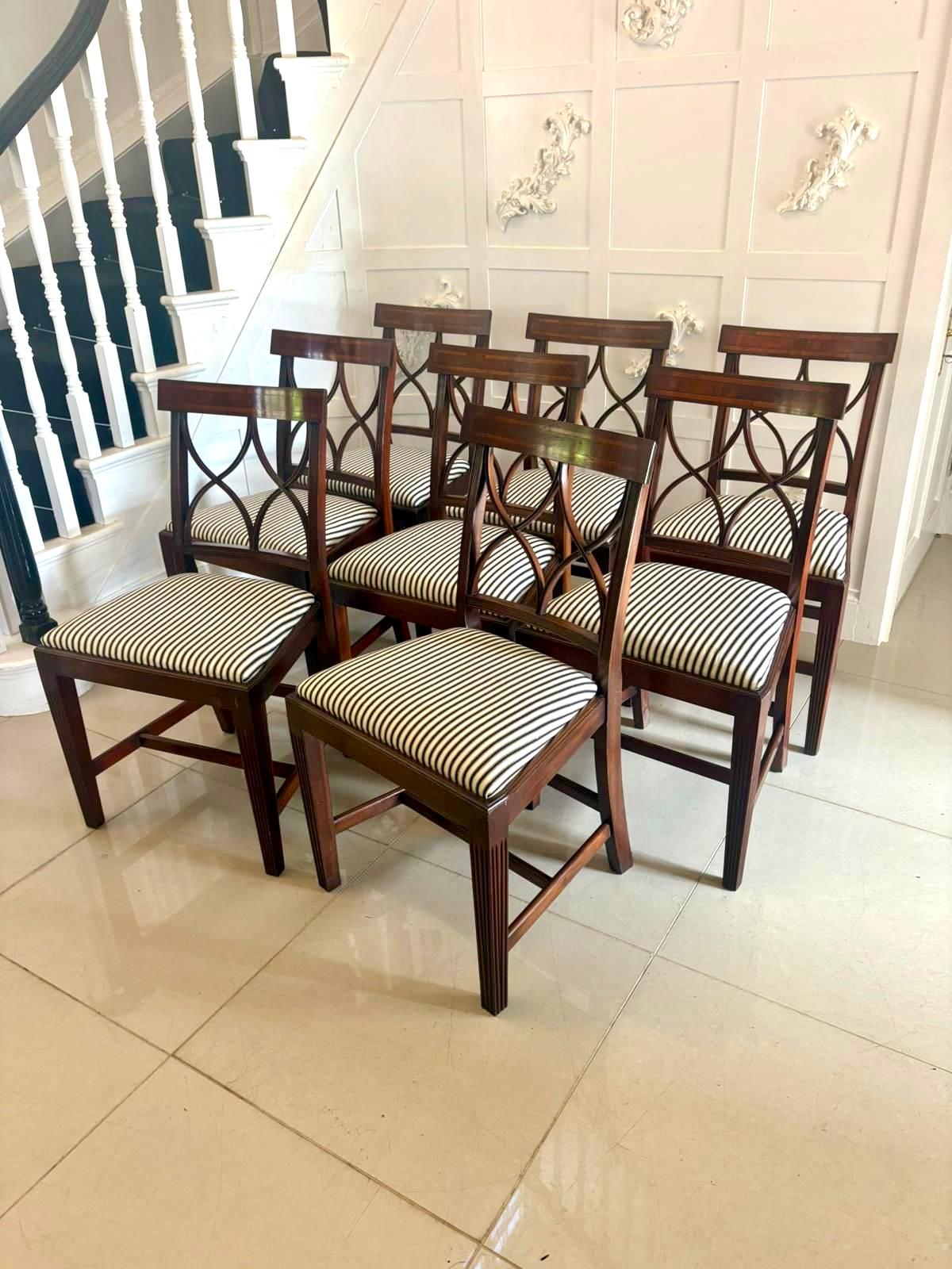A fine set of antique mahogany dining chairs comprising 6 single and 2 armchairs each crafted with refined geometric lattice backs, fluted front legs and well-proportioned frames in the neoclassical taste. The top rails feature boxwood line inlay