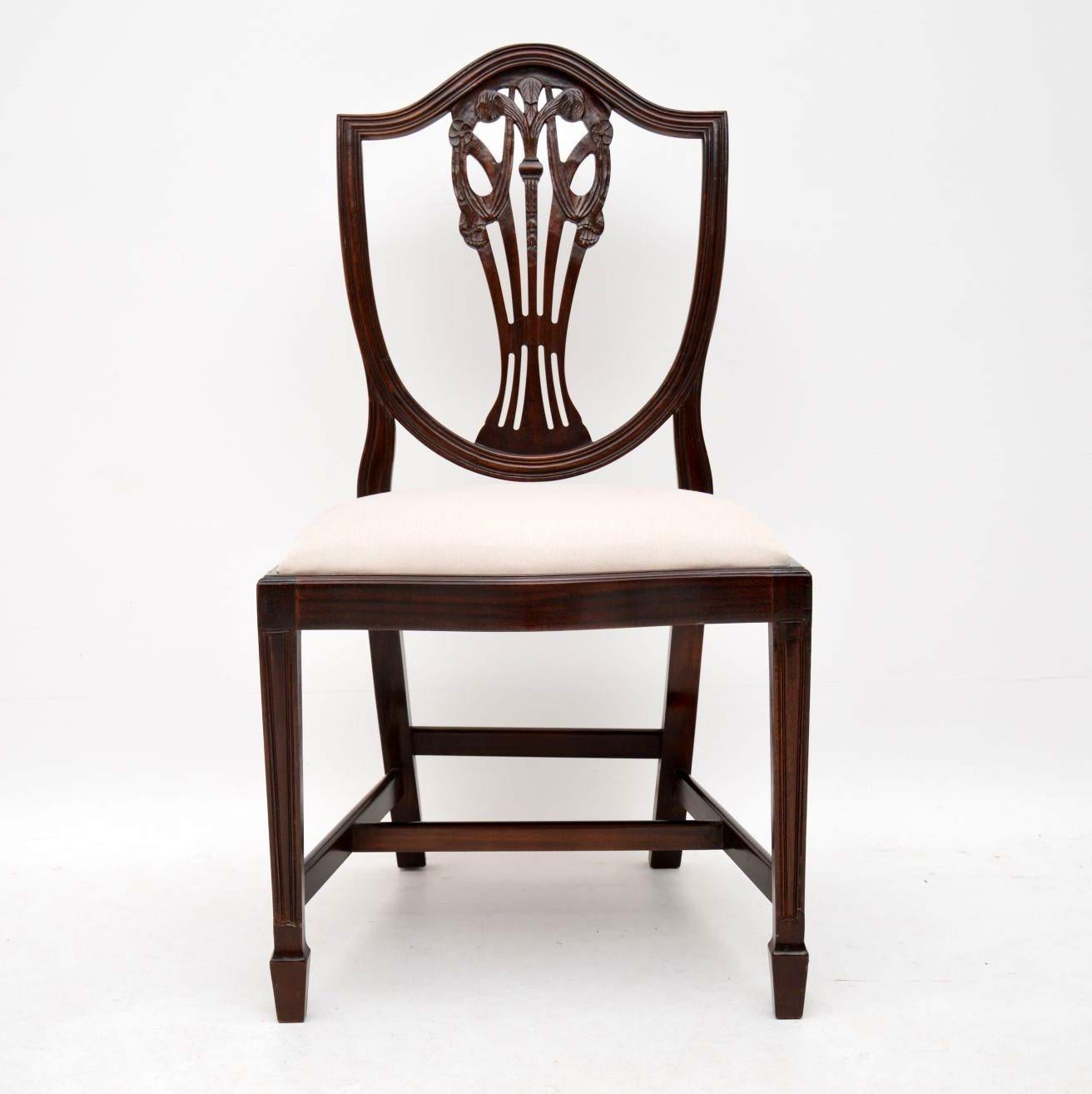 Set of eight antique Sheraton style dining chairs in mahogany including two with arms. They are in good condition, having just been French polished and I would date them to circa 1930s-1950s period. The drop in seats have just been re-upholstered in