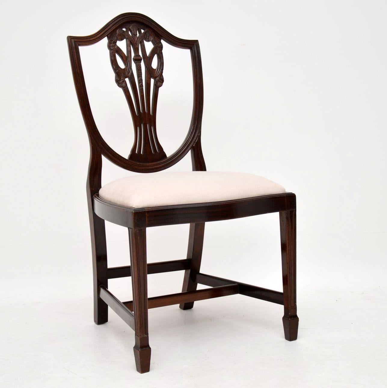 Set of eight antique Sheraton style dining chairs in mahogany including two with arms. They are in good condition, having just been French polished and I would date them to circa 1930s-1950s period. The drop in seats have just been re-upholstered in