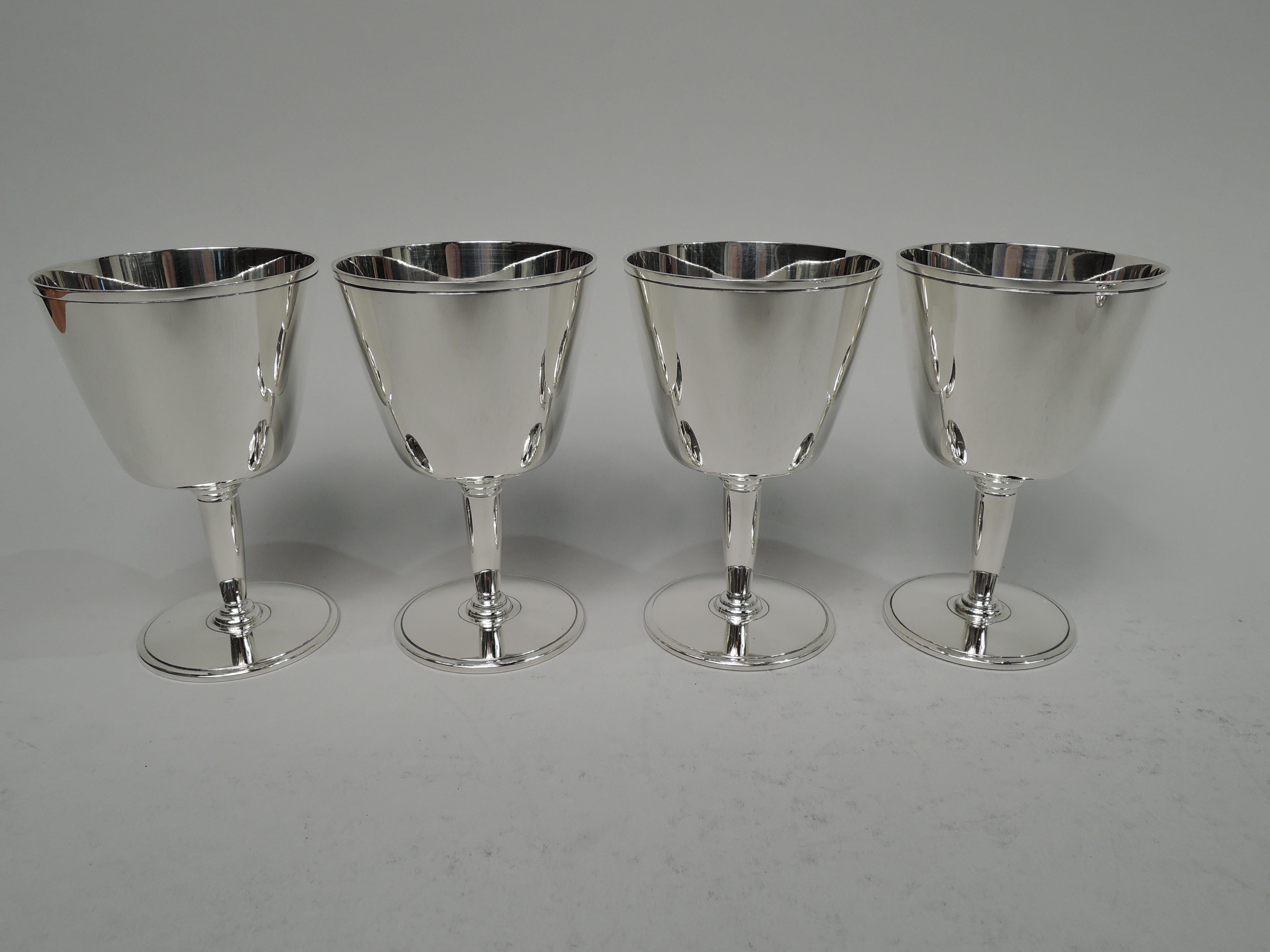 Set of 8 Art Deco sterling silver cocktail cups. Made by Tiffany & Co. in New York, ca 1929. Each: Tapering sides and flat bottom mounted to tapering stem on flat circular foot. Incised bands on rims and bowl underside. Spare and functional. Nice
