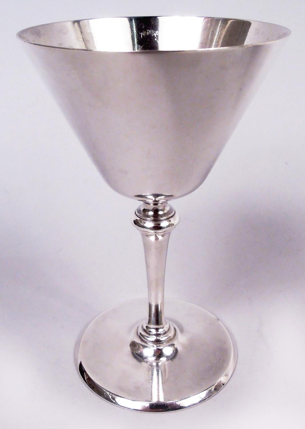 Set of 8 Art Deco sterling silver cocktail cups. Made by Tiffany & Co. in New York, ca 1922. Each: Conical bowl on tapering stem; round and raised foot. Fully marked including maker's stamp, pattern no. 20037 (first produced in 1922), and director’s