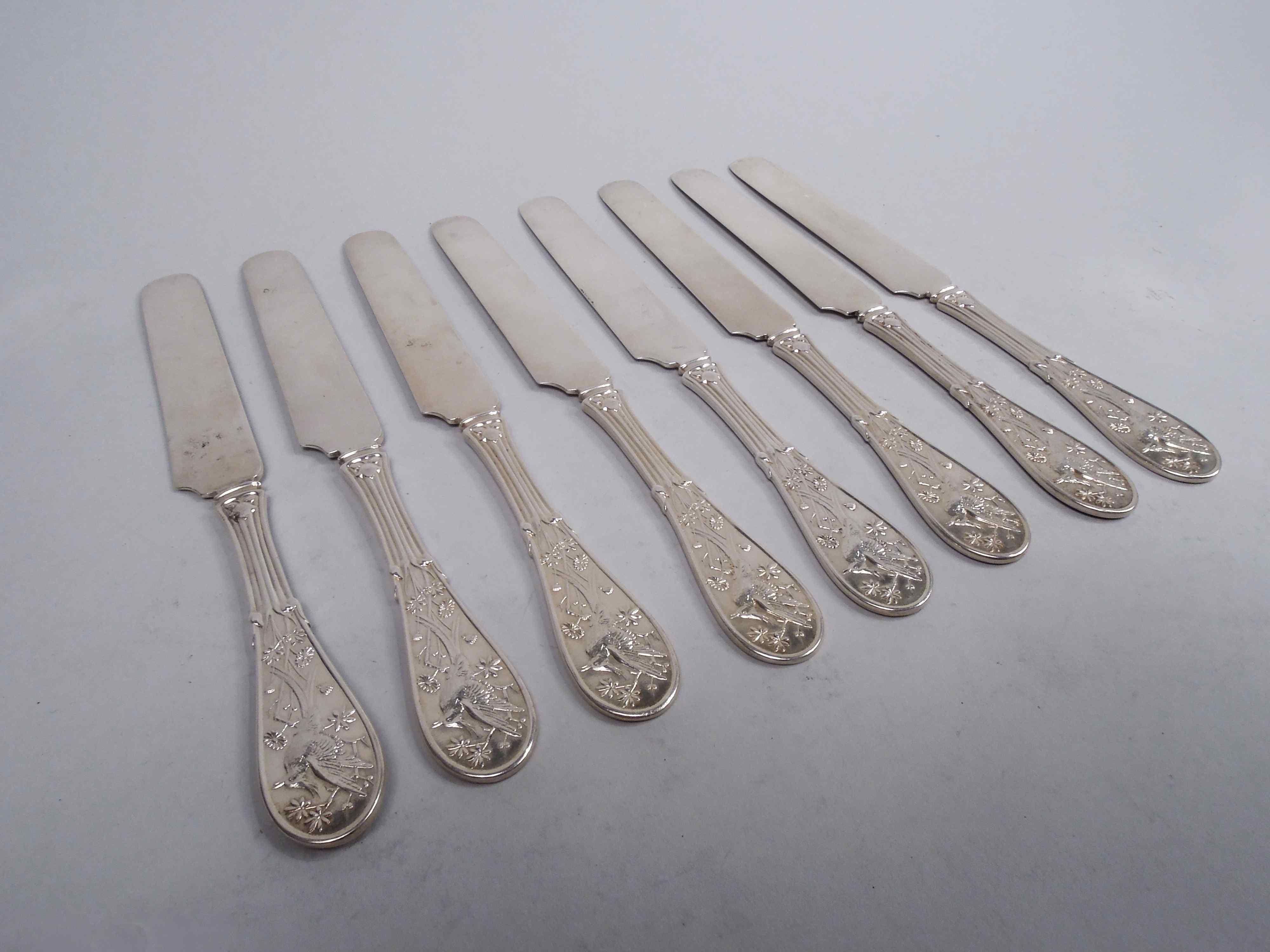 Set of 8 Japanese sterling silver breakfast knives. Made by Tiffany & Co. in New York, ca 1875. Reeded handle and oval terminal; double-sided low-relief stylized ornament with perched bird, flowers, leafing stalks, and cattails. The pattern was