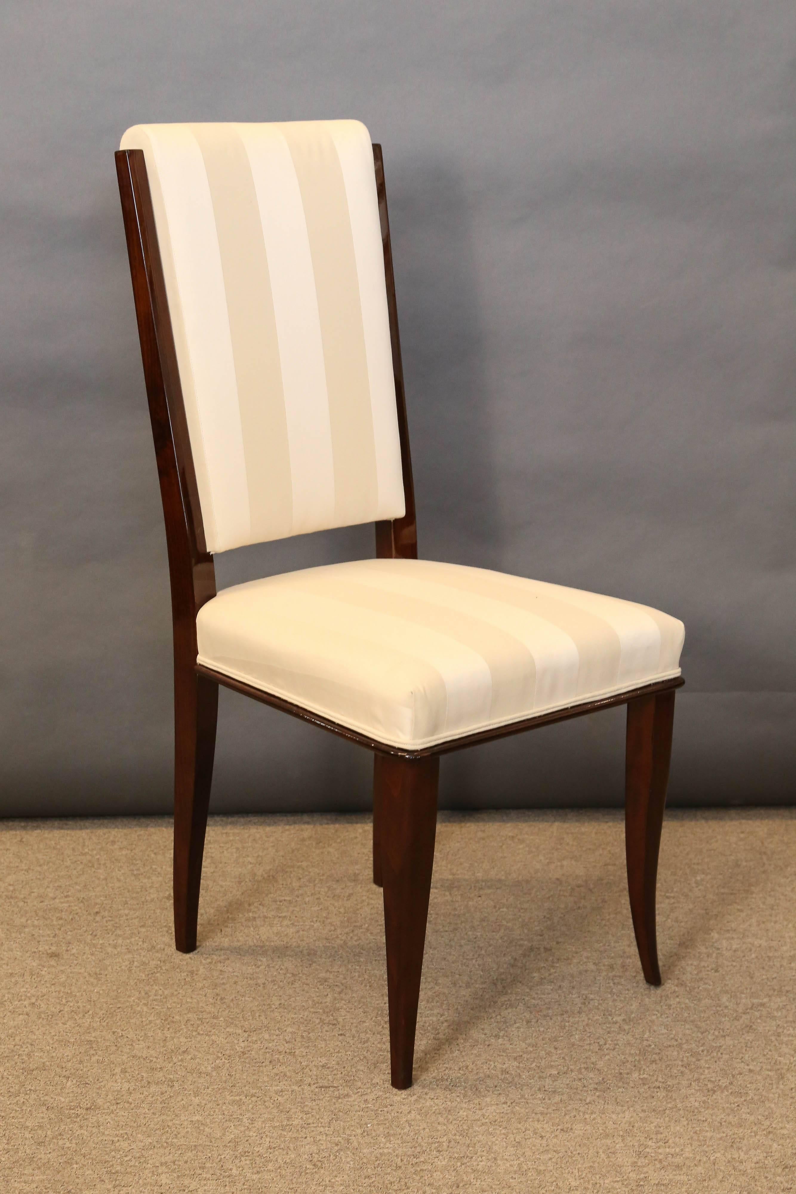 Chairs are newly re-upholstered in a light striped fabric. Back support is separated from the sit. Top of the back part is curved. Body of each chair is made out of height quality walnut wood.
Each chair is elevated by two slightly curved front