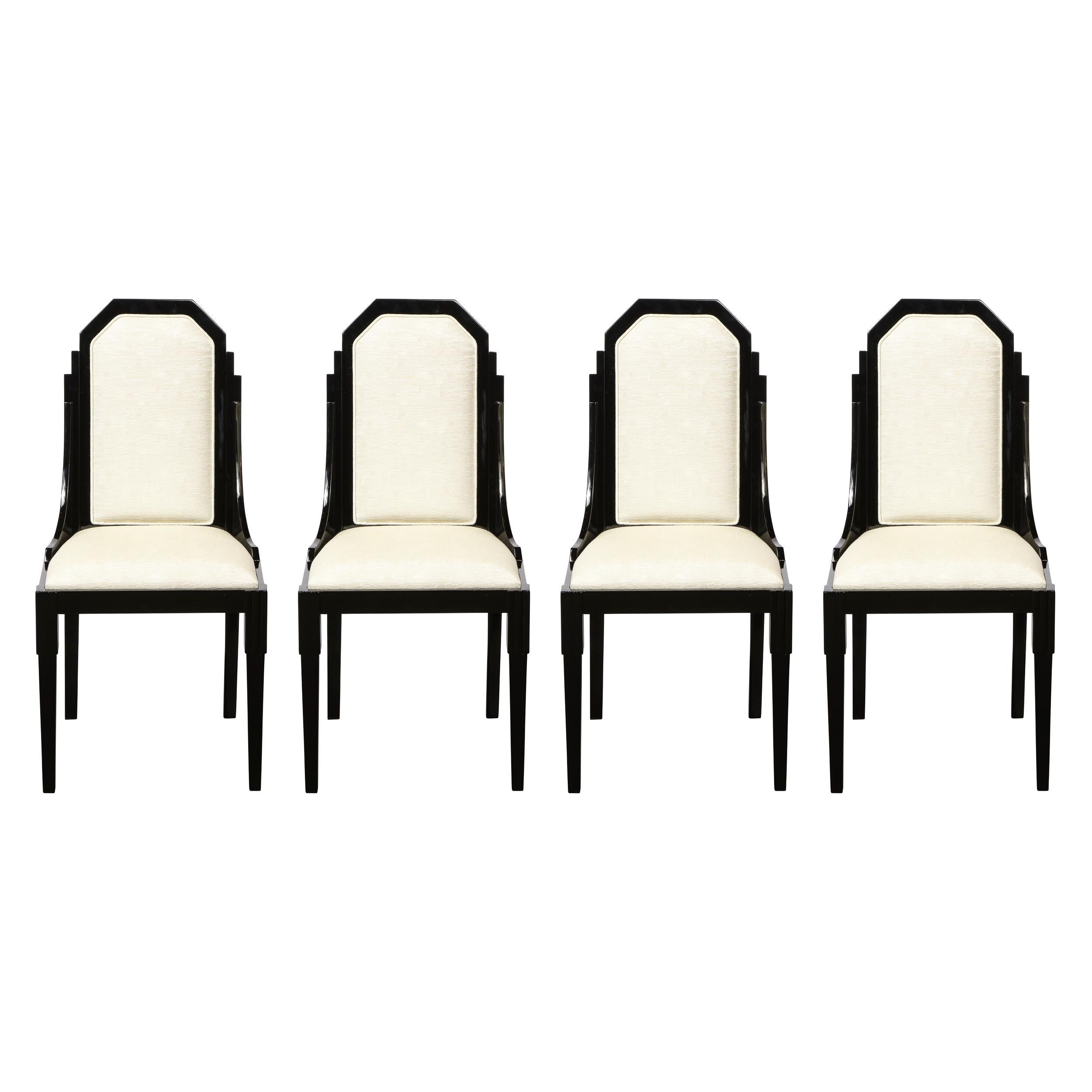 This stunning and graphic set of Art Deco Machine Age dining chairs were realized in the United States circa 1935. They features streamlined sides; subtly bowed hind legs and tapered front legs with skyscraper style detailing at their apex. The