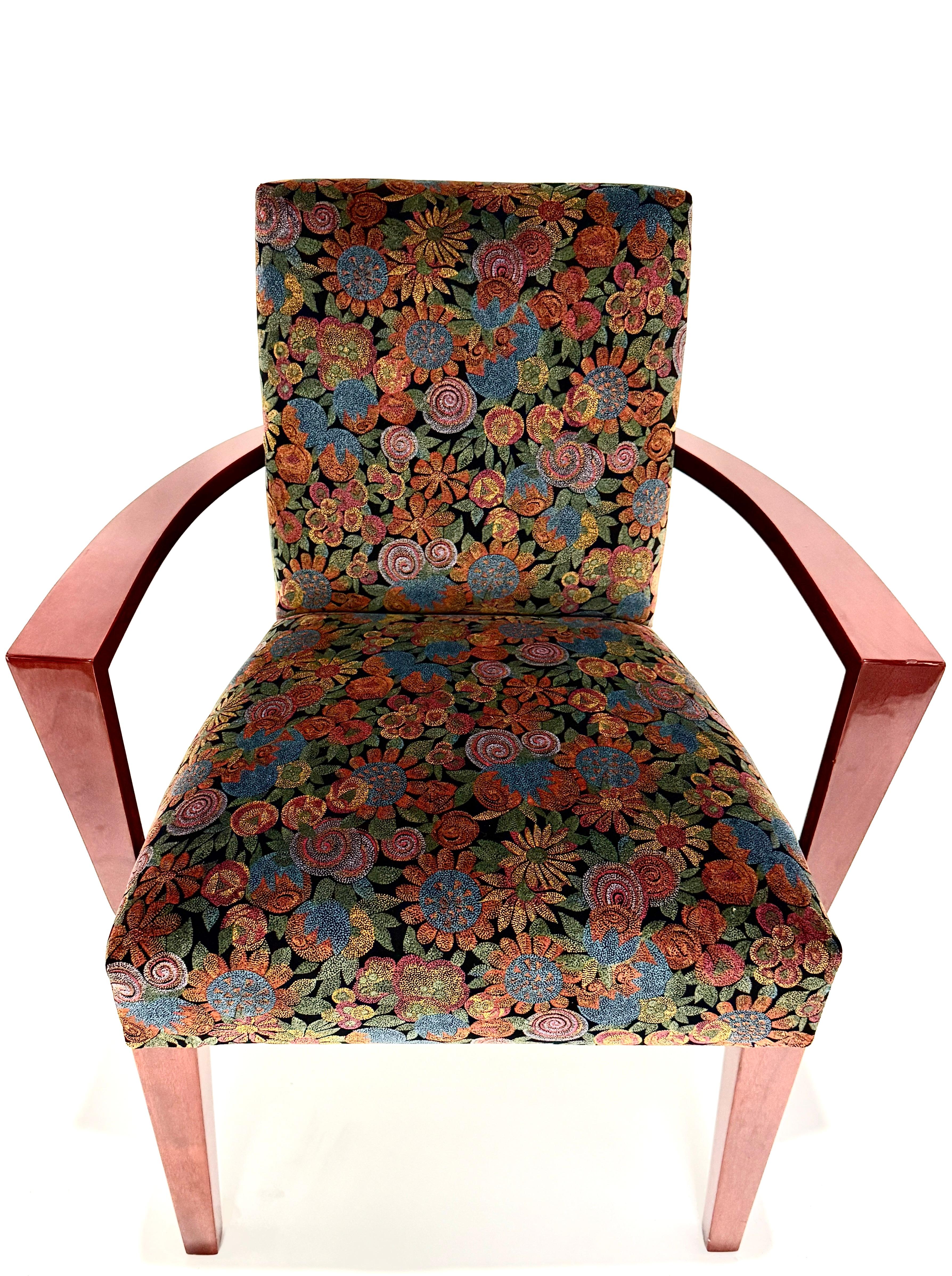 A striking set of eight dining chairs in the Art Deco style, comprising six side chairs and two armchairs. These elegant chairs feature a richly colored period-style floral upholstery with a sophisticated, stylized pattern evocative of the early