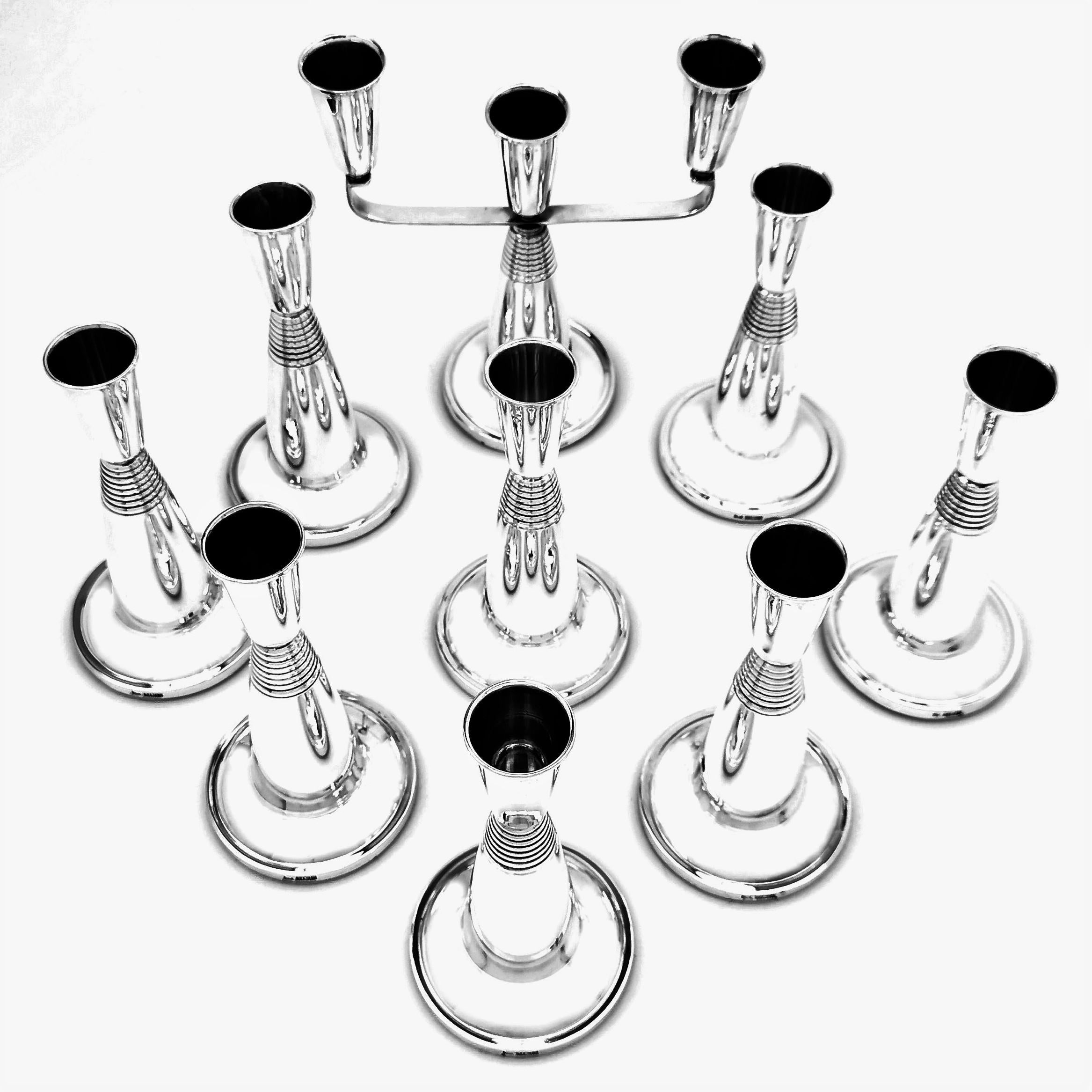 A gorgeous suite of 8 sterling Silver Candlesticks and a matching sterling Silver Candelabrum in a modern Art Deco style. This set can be used in any number of combinations making them very versatile in any space.

Made in Birmingham, UK in 1990 by