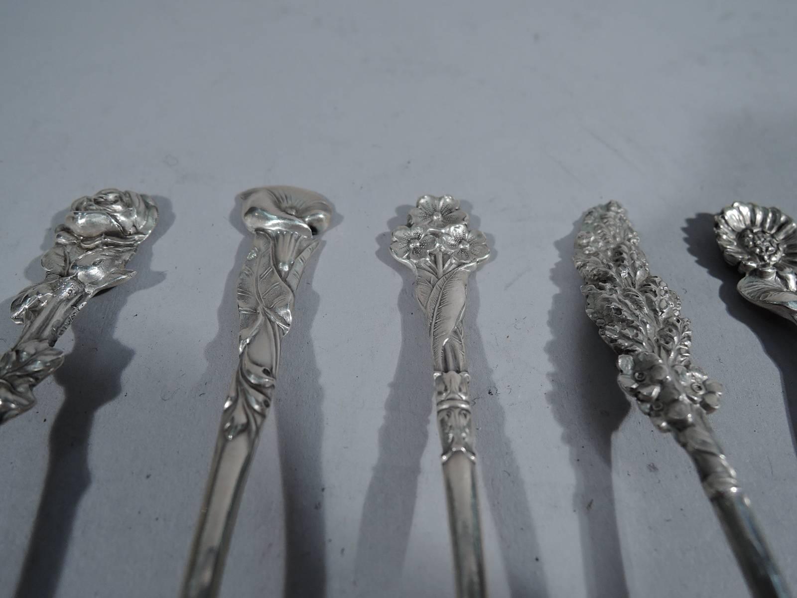 Set of 8 antique sterling silver demitasse spoons in Harlequin pattern. Made by Reed & Barton in Taunton, Mass. Each: Oval gilt bowl with shaped flower terminal. Each different including roses, forget me nots, and morning glories. A pretty bunch