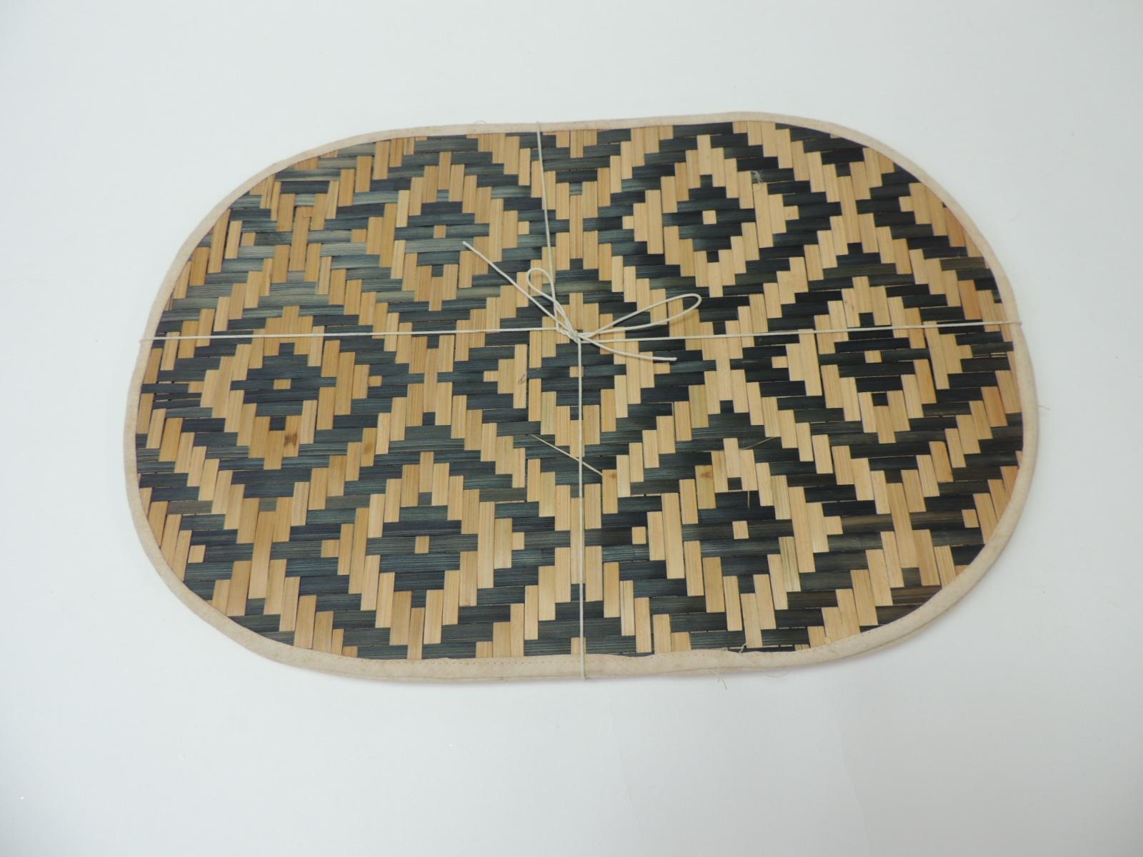 Set of 8 bamboo and raffia woven oval placemats. Black and natural graphic woven placemats with small cotton trim.
Size: 12 x 18.