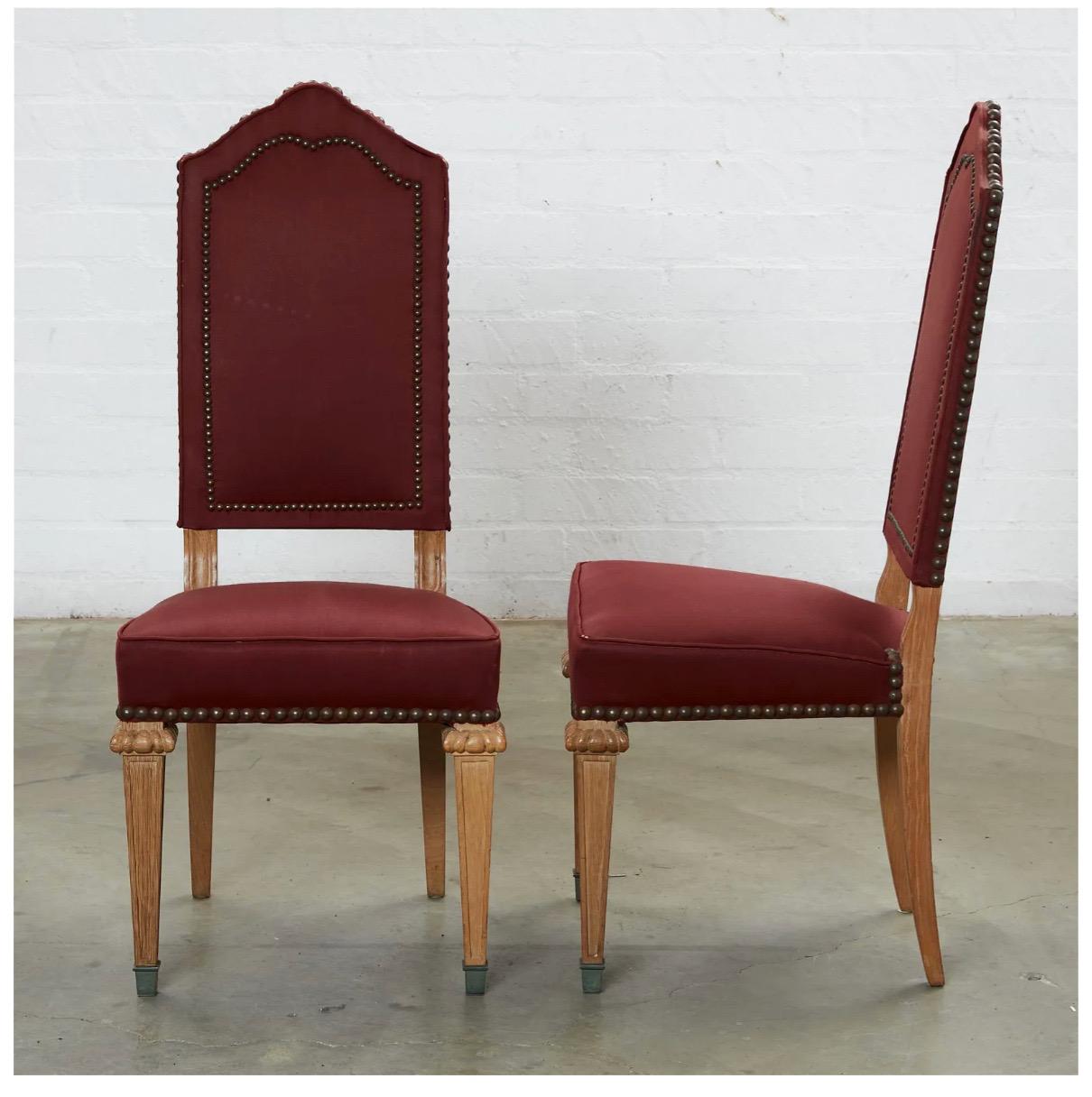 This is a very good set of 8 French Oak Baroque-Style dining chairs that date to the second half of the 20th century. All 8 chairs are in very good condition as is the deep wine-toned upholstery. The upholstery is well-detailed in patinated brass