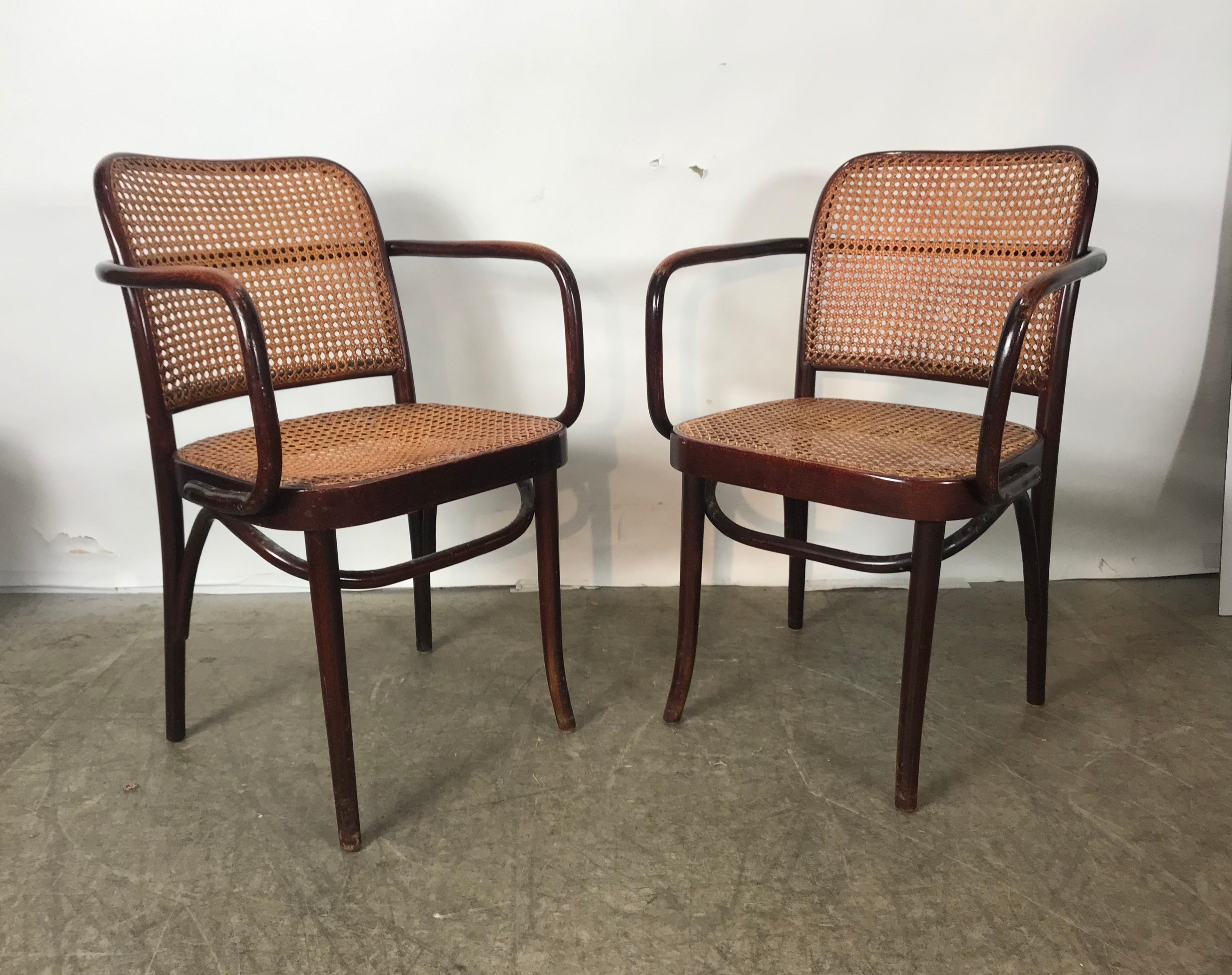 Classic set of wood and cane dining chairs originally designed in 1905 by Josef Hoffmann, set featuring 2-arm chairs and 6 side chairs, some chairs retain original FMG Poland label, nice worn patina, my guess is they date circa 1960s, 1970s.