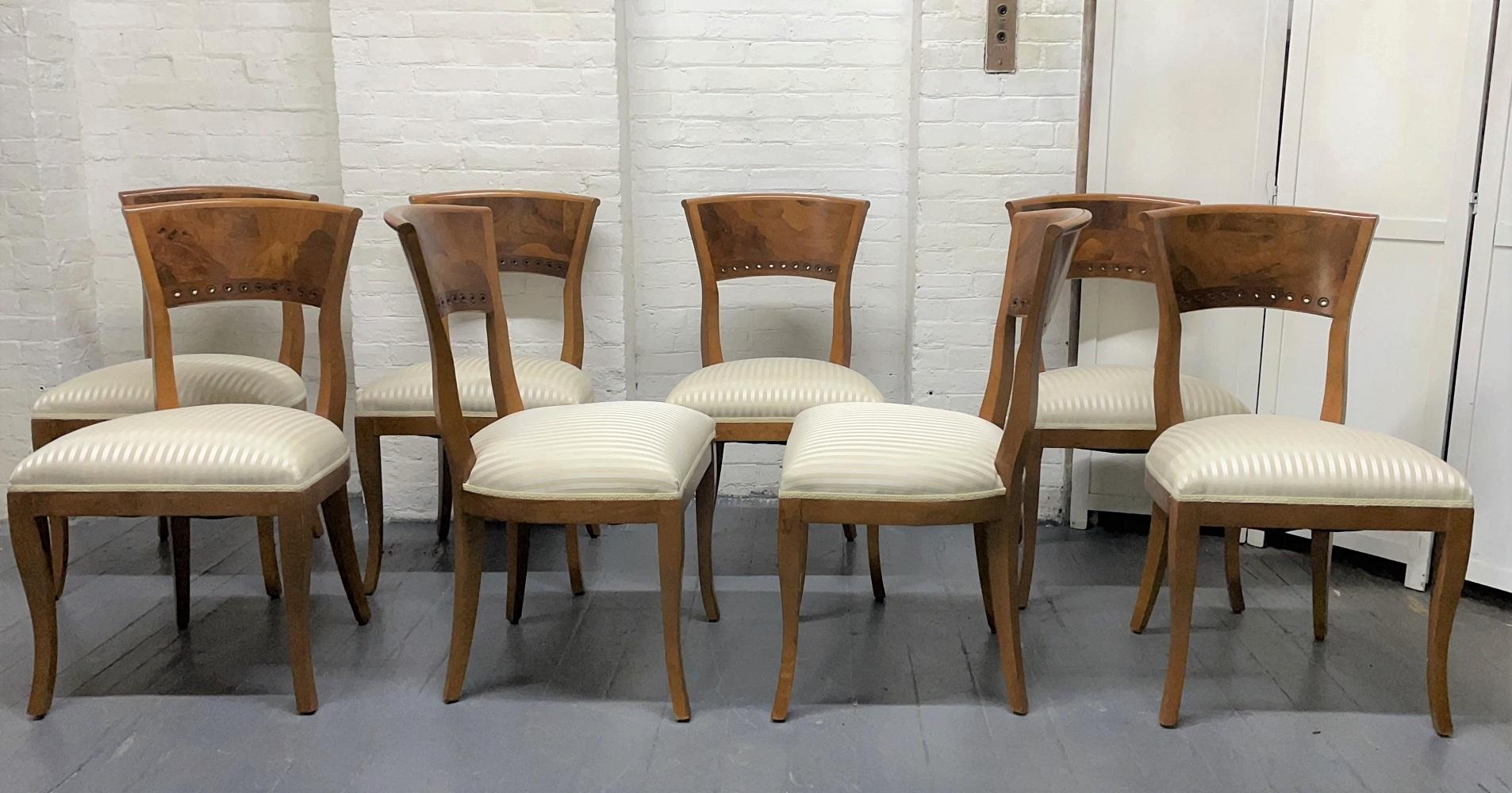 Set of 8 Biedermeier style dining chairs. The chairs are cherry and have walnut burlwood backs.
