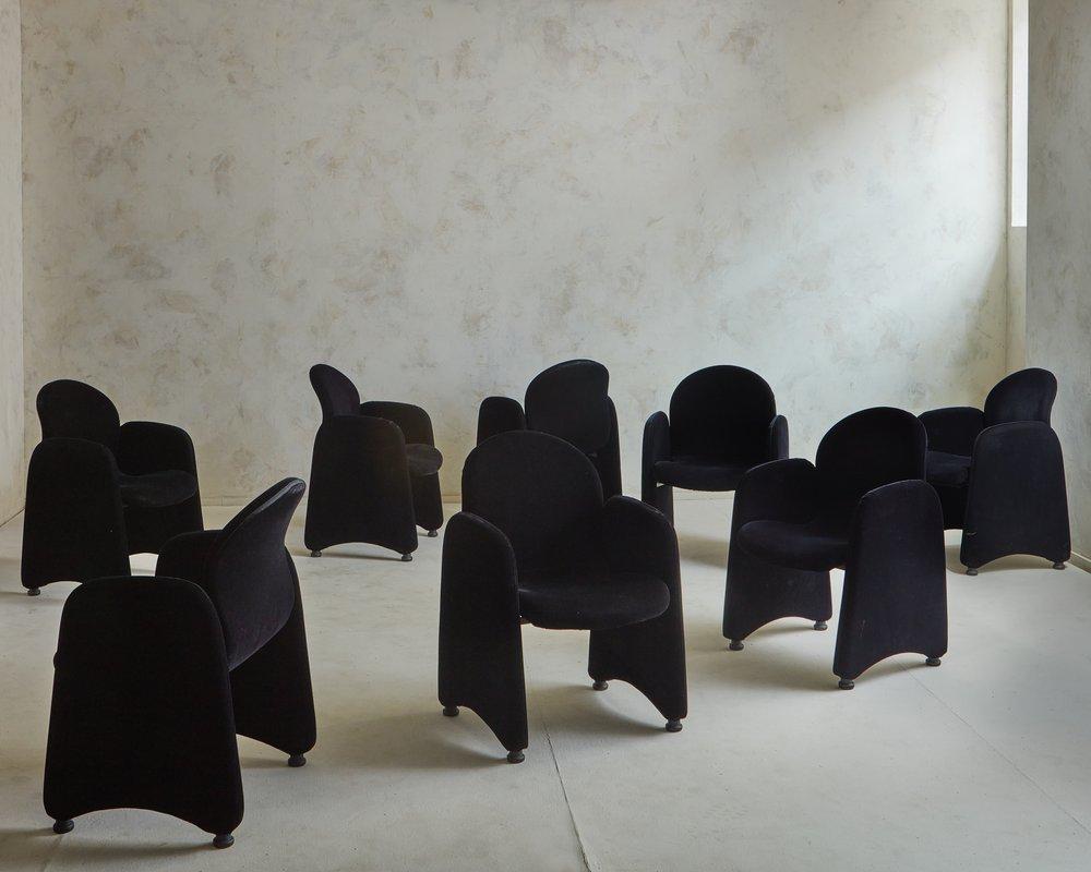 A set of 8 vintage dining chairs in the style of Luigi Caccia Dominioni. These chairs retain their original black velvet upholstery and stand on circular acrylic feet. We love the sculptural silhouette + dramatic curves on this beautiful set.