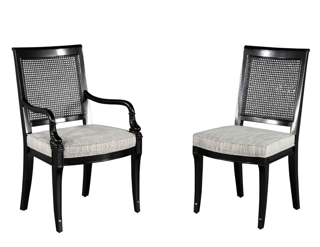 Set of 8 black lacquered cane back dining chairs. Masterfully restored in a satin black lacquer finish with all new upholstery work. Fabric is a high-performance textured linen with tones of grey, black and charcoal. Featuring detailed cane work