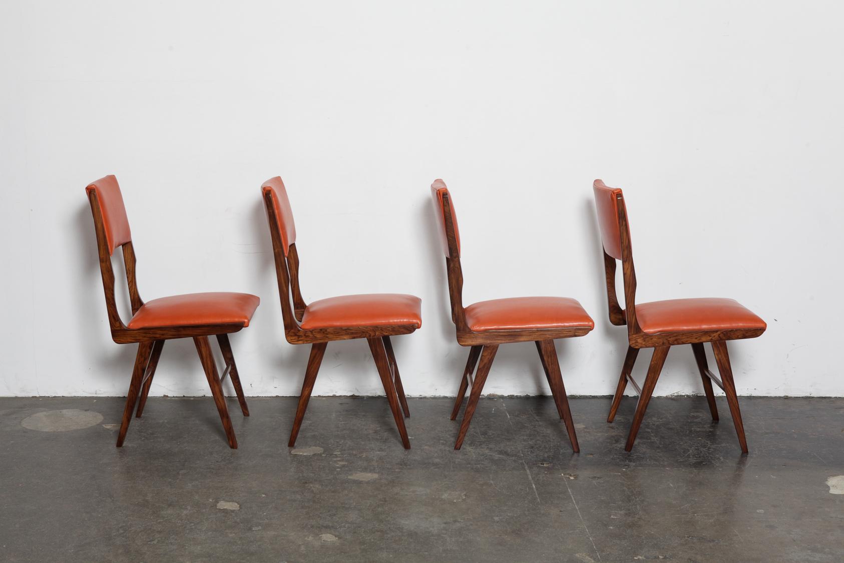 Set of 8 tall back beautiful vintage Brazilian solid rosewood dining chairs, newly upholstered in a burnt orange leather and refinished in lacquer, 1960s Brazil. Designer unknown.