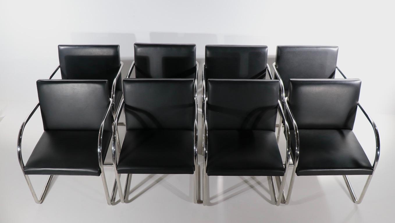 Set of 8 dining chairs known as the Brno chair, originally designed by Ludwig Meis van der Rohe, this set was produced by Knoll, probably circa 1970's vintage. Top quality black leather seats and backs, bright tubular chrome cantilevered frames.