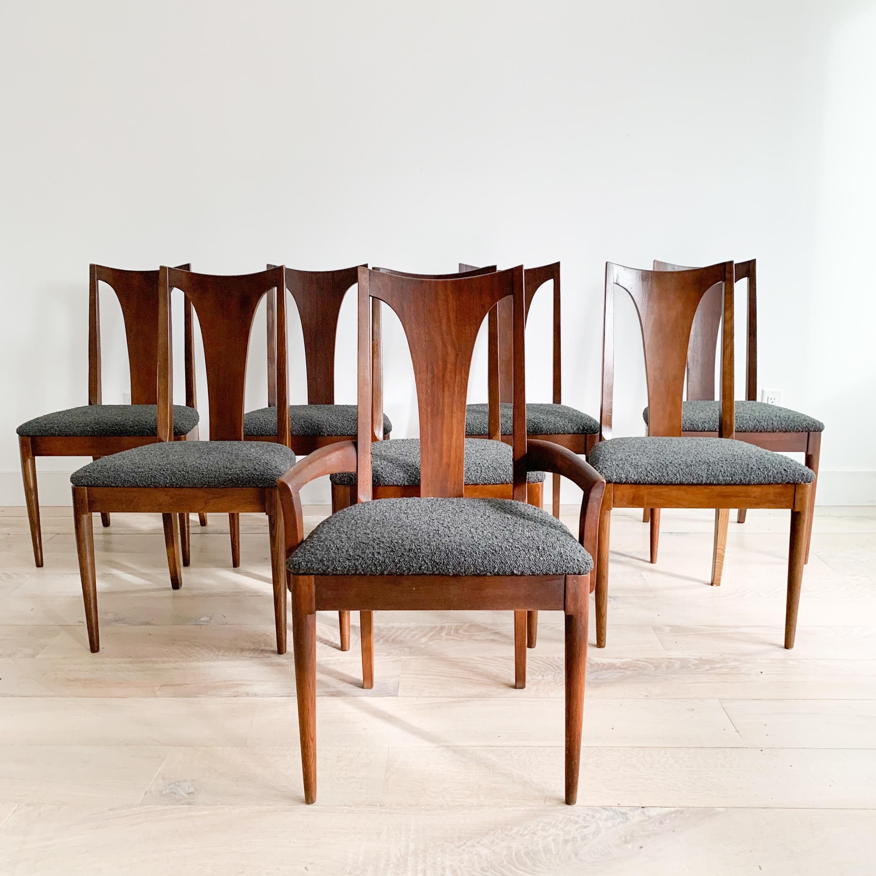 Set of 8 mid century modern dining chairs by the Broyhill Brasilia line. Some light scuffing/scratching/small areas of veneer repair. New charcoal grey boucle upholstery.
